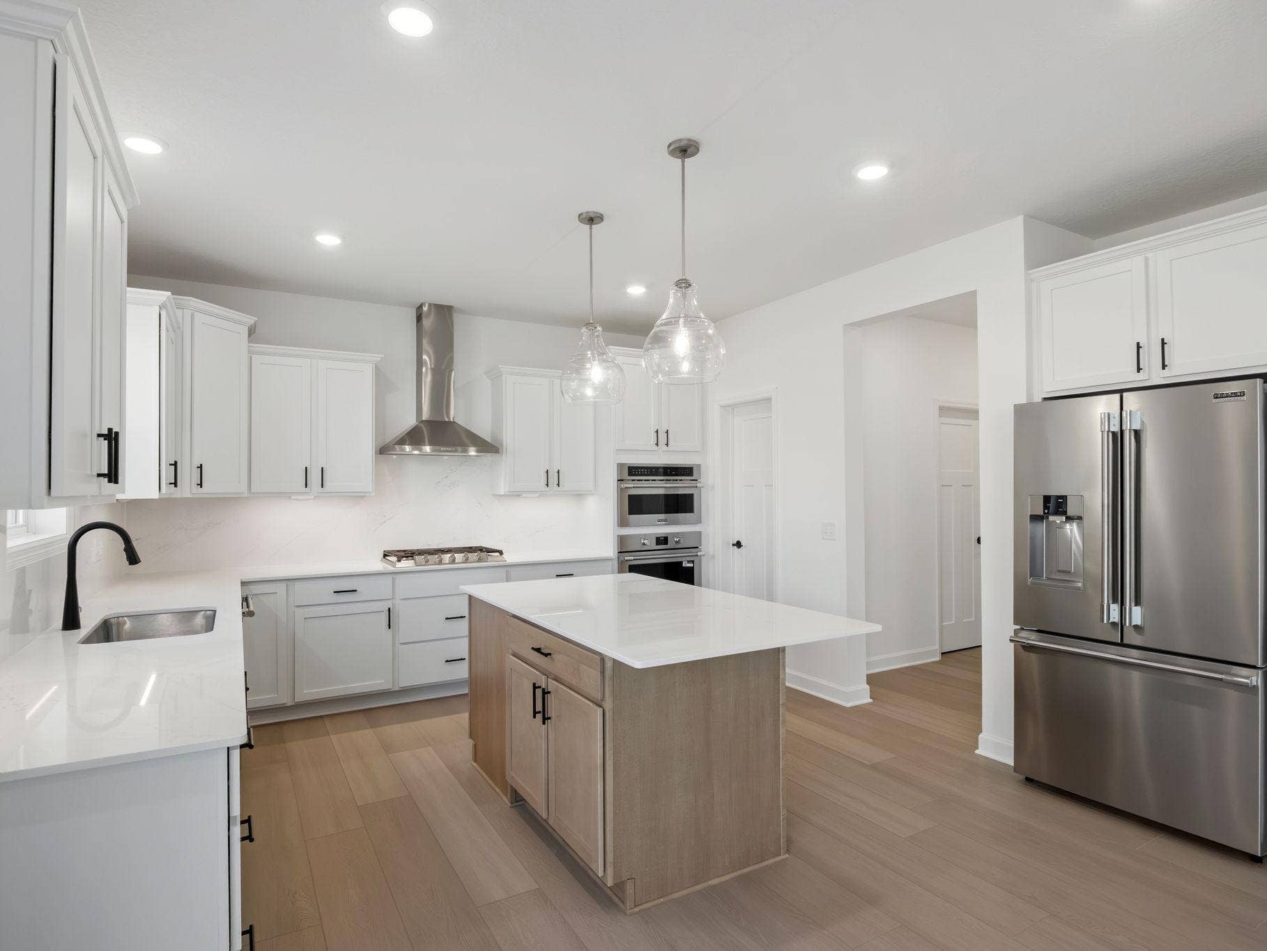 8656 Periwinkle Boulevard, Woodbury, MN 55129 The kitchen has ease-of-access to the mudroom and flows seamlessly into the dining room