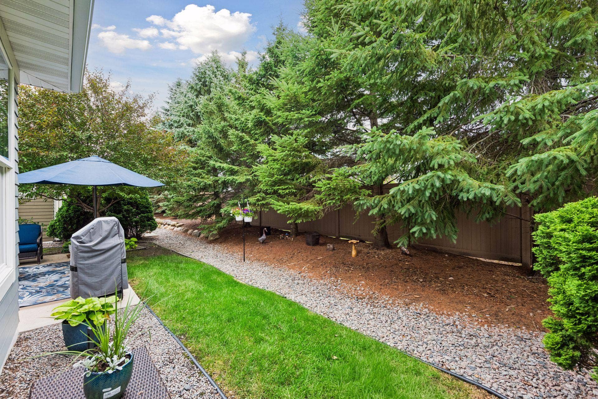 5010 Dale Ridge Road, Woodbury, MN 55129 Nice yard and rock area off of your back patio.