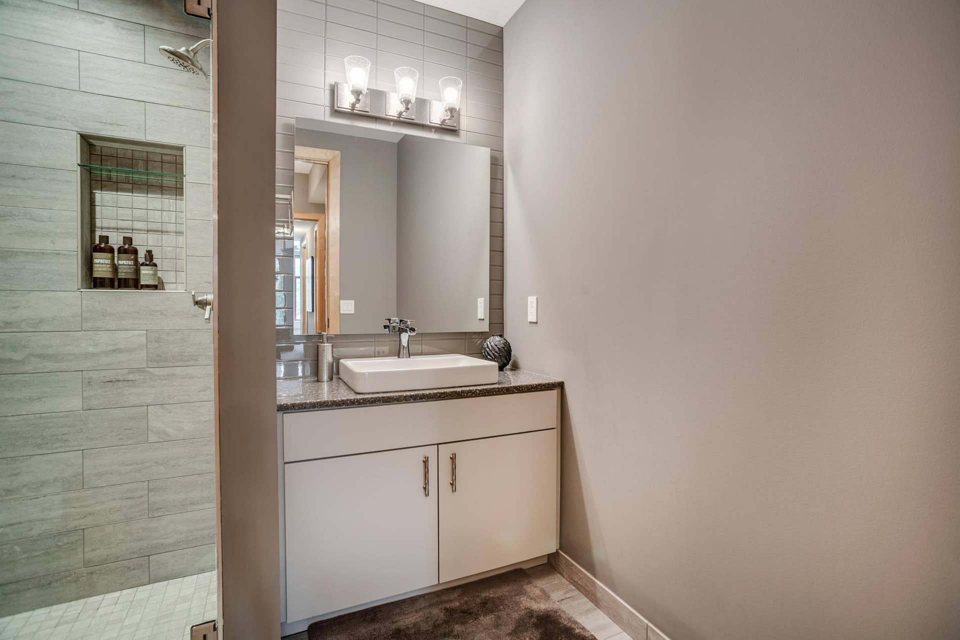 600 S 2nd Street, #S108, 18, Minneapolis, MN 55401 The designer bathroom is conveniently situated near the second bedroom.