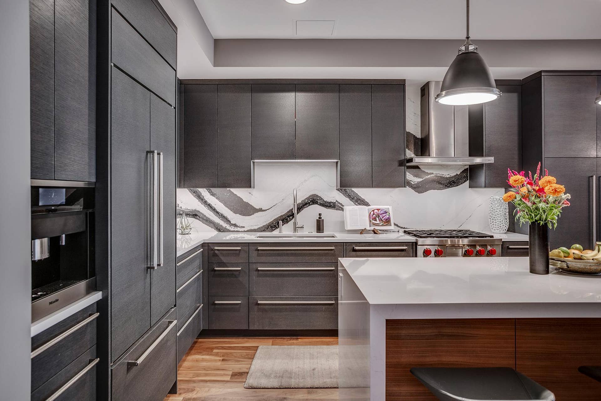 600 S 2nd Street, #S108, 18, Minneapolis, MN 55401 The chefs kitchen features a striking waterfall island with seating, Cambria countertops and statement backsplash, Wolf and Sub-Zero appliances, Miele built-in coffee maker, and gorgeous custom cabinetry.