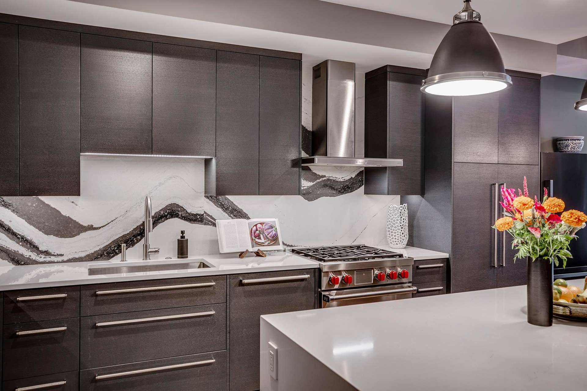 600 S 2nd Street, #S108, 18, Minneapolis, MN 55401 The chefs kitchen features a striking waterfall island with seating, Cambria countertops and statement backsplash, Wolf and Sub-Zero appliances, Miele built-in coffee maker, and gorgeous custom cabinetry.
