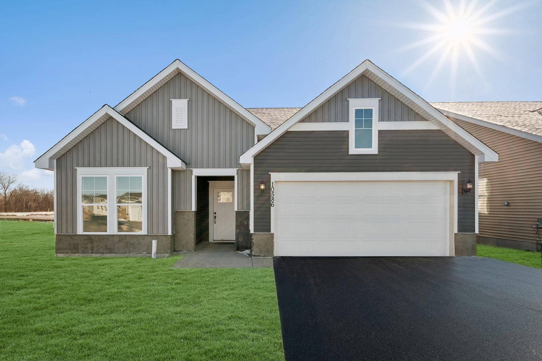 14756 105th Circle N, Maple Grove, MN 55369 Welcome to the Oriole. Landscaping, sod, irrigation, asphalt driveway, and mulch included. Virtually staged sod and driveway.