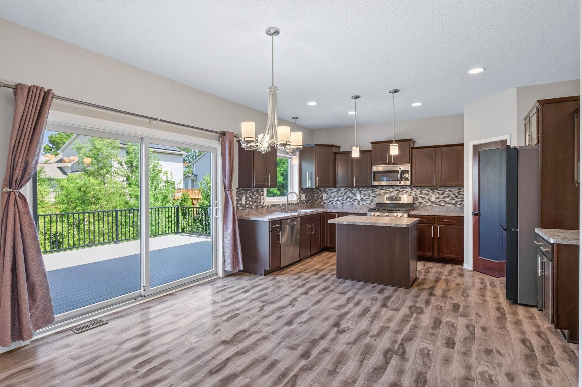 Main level kitchen, dining area, and access to deck