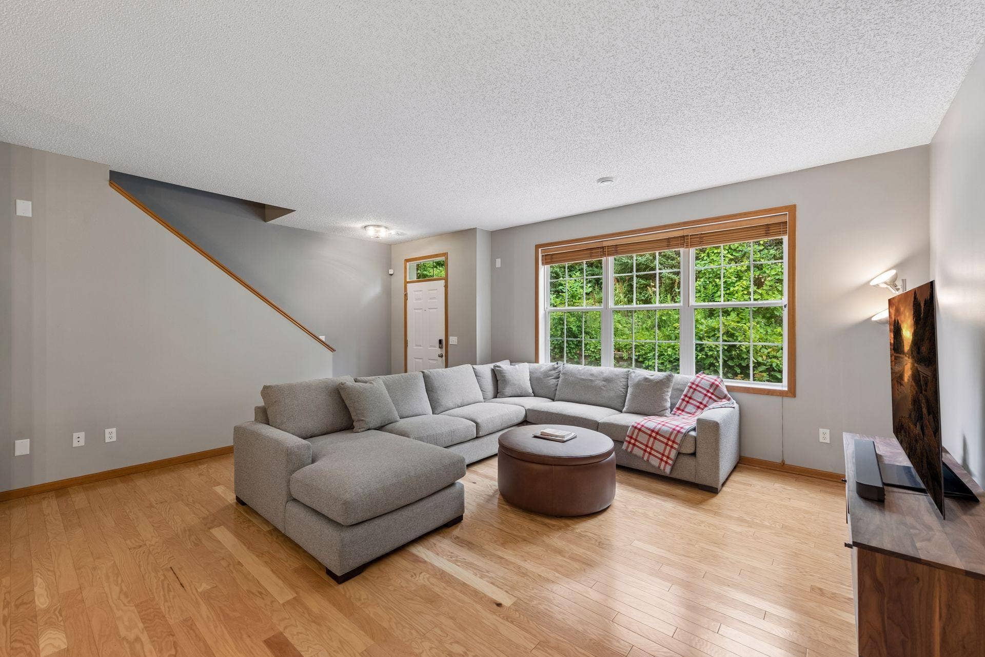 11025 Oak Grove Circle, #C, Woodbury, MN 55129 Spacious family room has gorgeous engineered hardwood floors. Neutral colors make this home move-in ready.