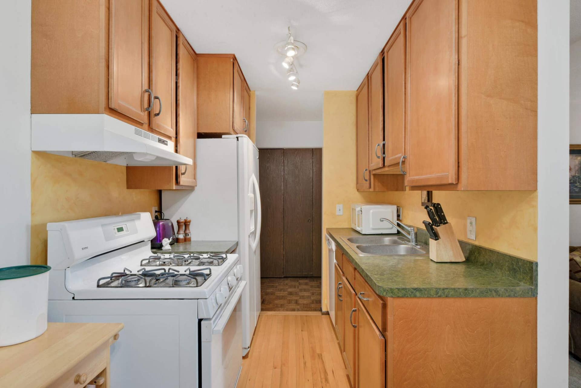 4201 Lakeside Avenue N, #113, Brooklyn Center, MN 55429 Another view of the kitchen showcasing plentiful cabinetry, updated appliances, and easy access to the dining area.