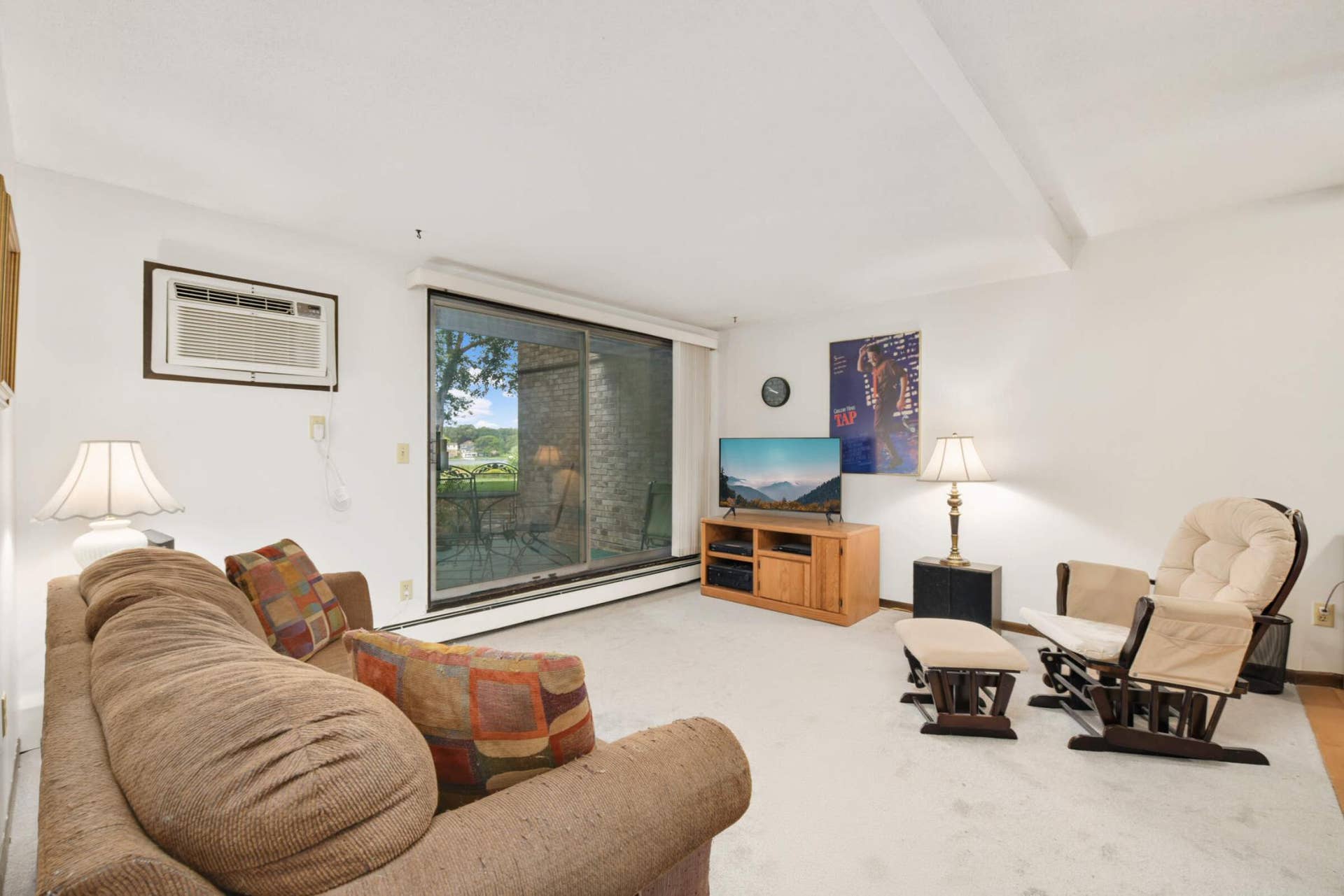 4201 Lakeside Avenue N, #113, Brooklyn Center, MN 55429 Bright, spacious living room featuring a large sliding glass door that fills the space with natural light and opens to your private patio.