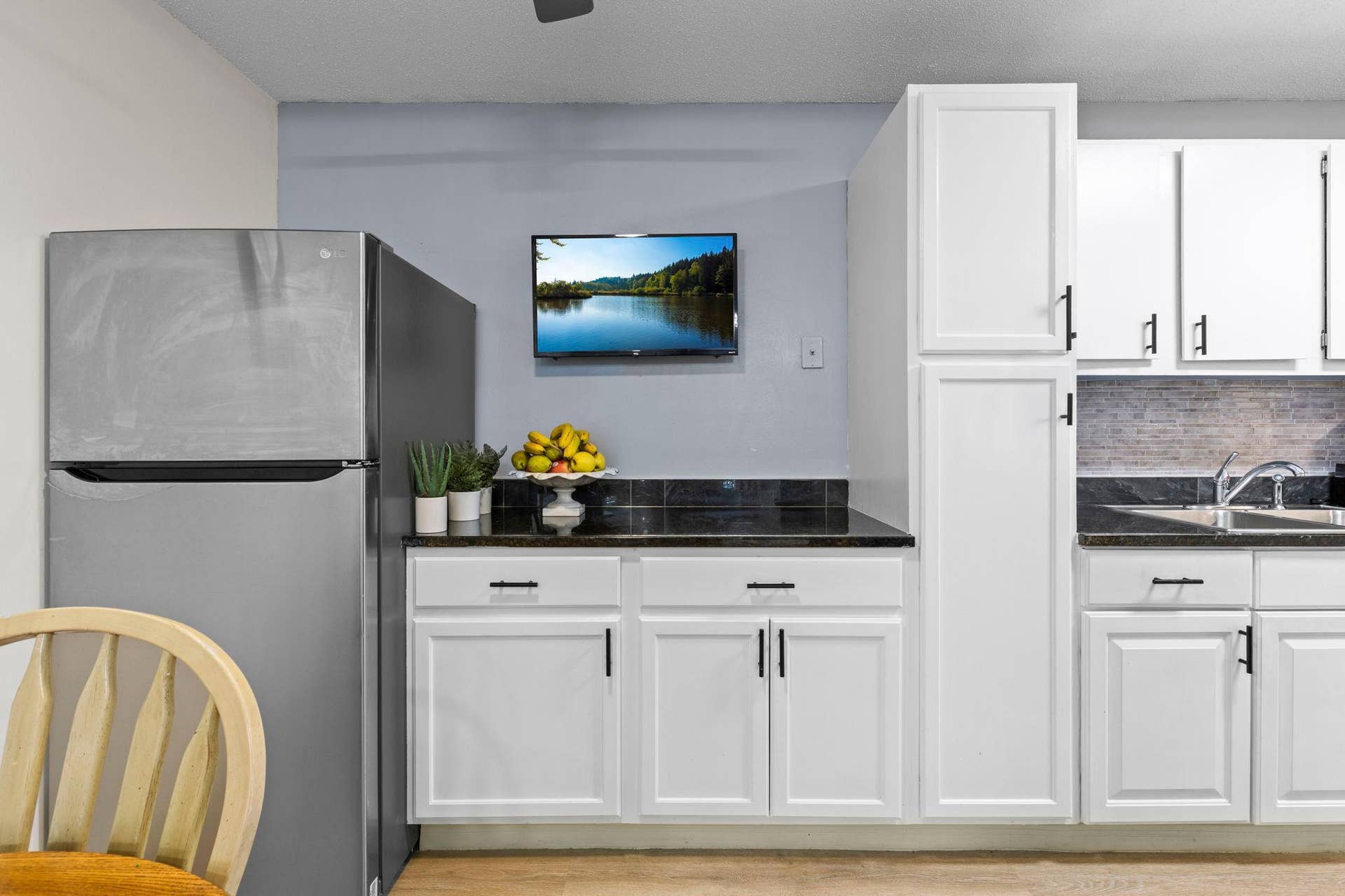 4201 Lakeside Avenue N, #214, Brooklyn Center, MN 55429 Another view of the kitchen highlights the seamless flow into the dining area, providing additional counter space and creating a functional space for entertaining.