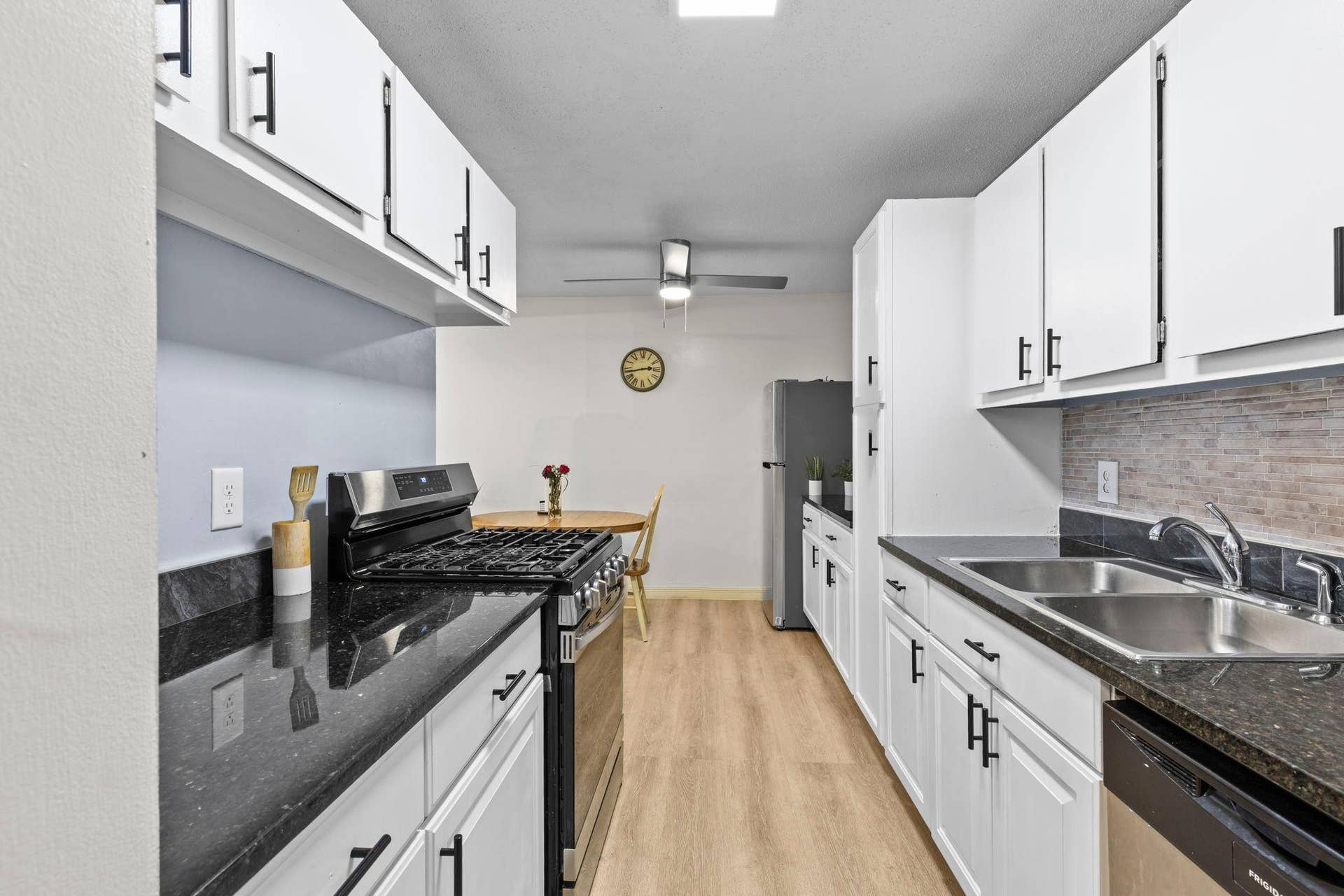 4201 Lakeside Avenue N, #214, Brooklyn Center, MN 55429 The kitchen offers stainless steel appliances, ample white cabinetry, and generous granite countertops, creating a functional and inviting space that flows seamlessly into the dining area.