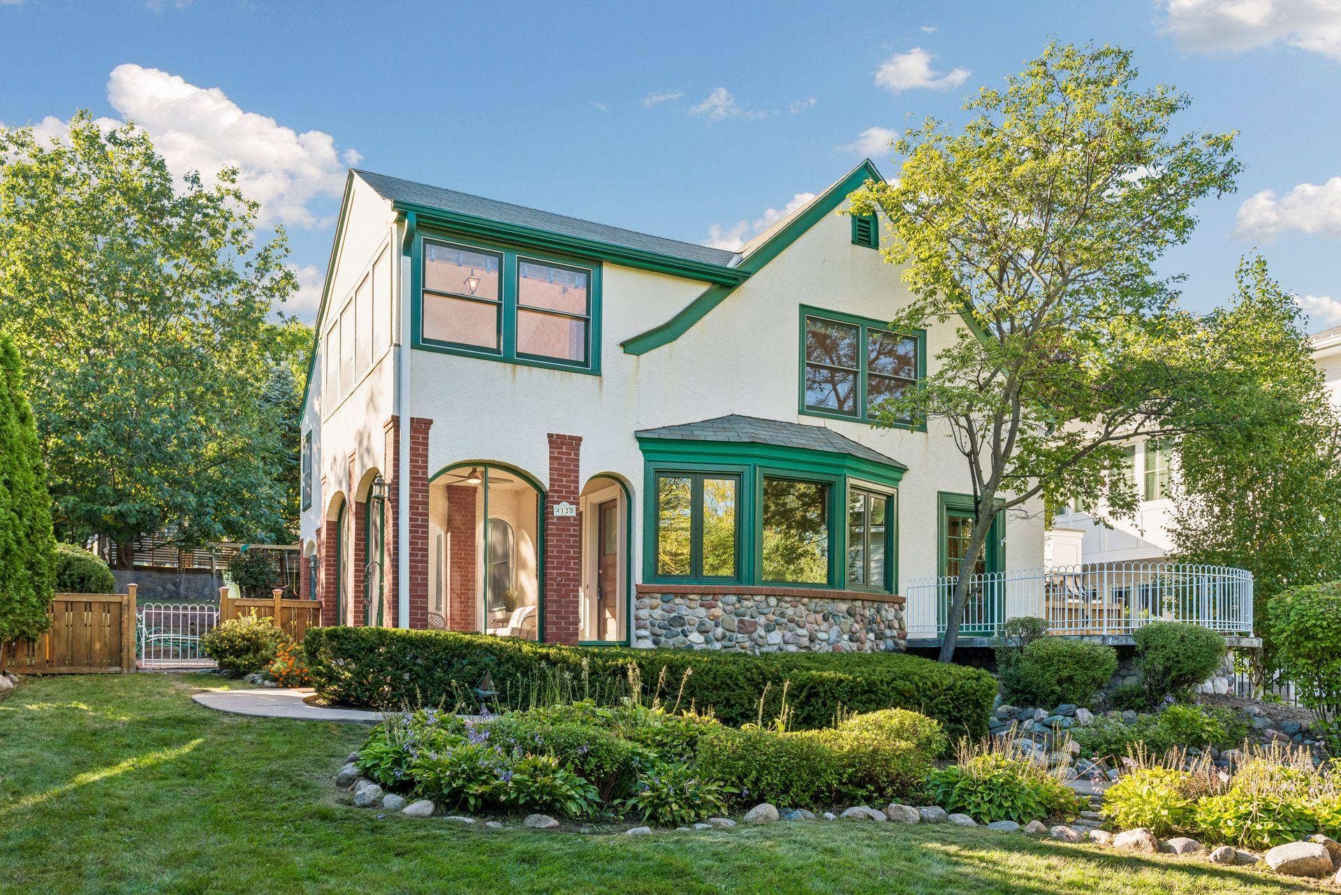 4120 Queen Avenue S, 42, Minneapolis, MN 55410 Striking Tudor-style exterior framed by mature landscaping and a manicured front garden