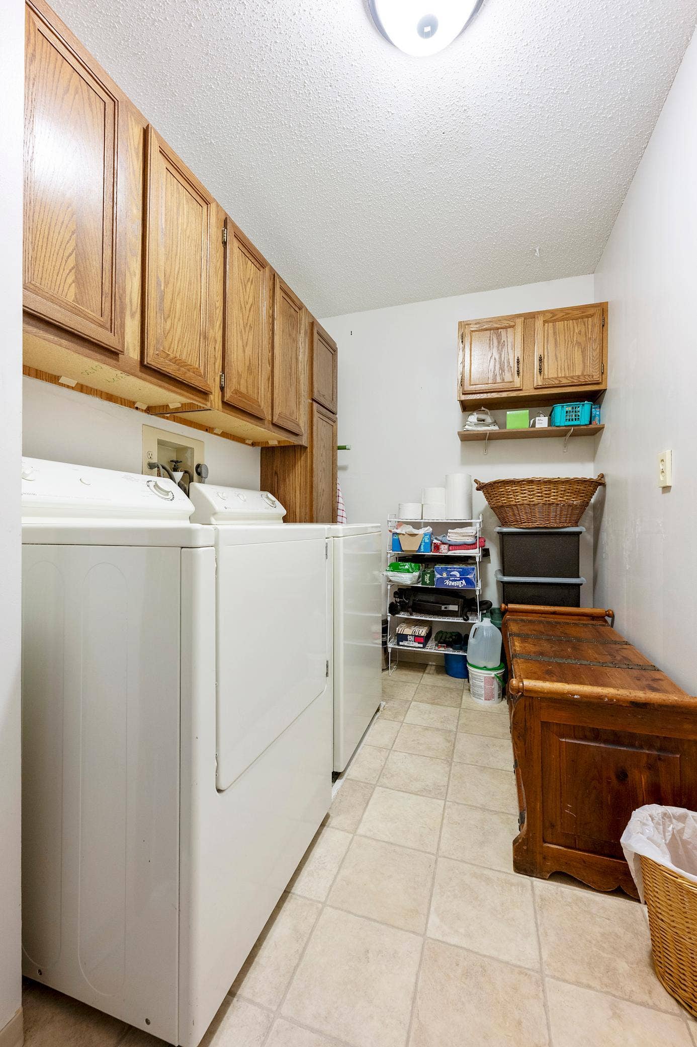 1800 Riverwood Drive, #301, Burnsville, MN 55337 This in-unit laundry room is amazing! Large enough for this full size washer/dryer pair flanked by a wall of wood cabinets and plenty of room to spare.