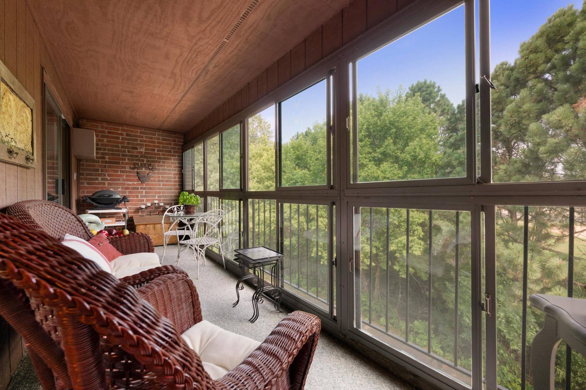 1800 Riverwood Drive, #301, Burnsville, MN 55337 An incredibly rare find: a glass-enclosed top-floor screen porch with treetop views and no buildings in sight.