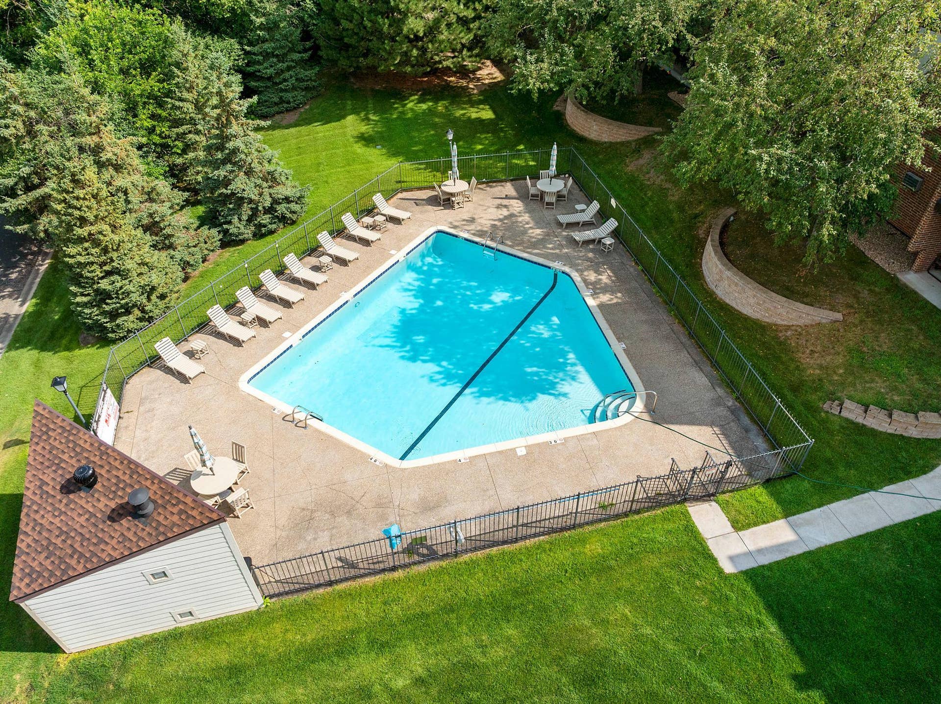1800 Riverwood Drive, #301, Burnsville, MN 55337 The large, well-maintained heated in-ground pool, complete with pool house and spacious concrete deck.