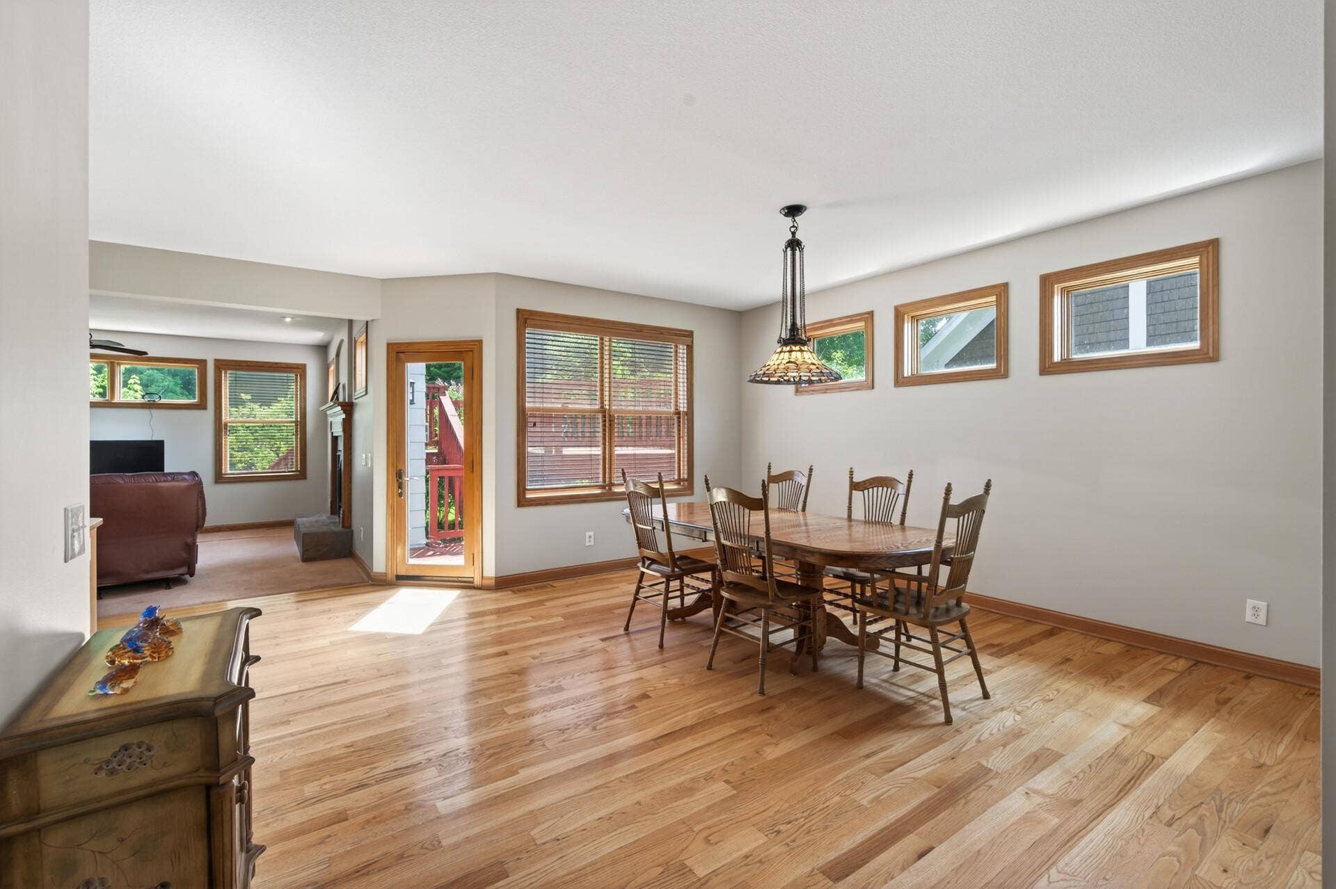 Plenty of natural light! Door to the deck in between the table and living room.