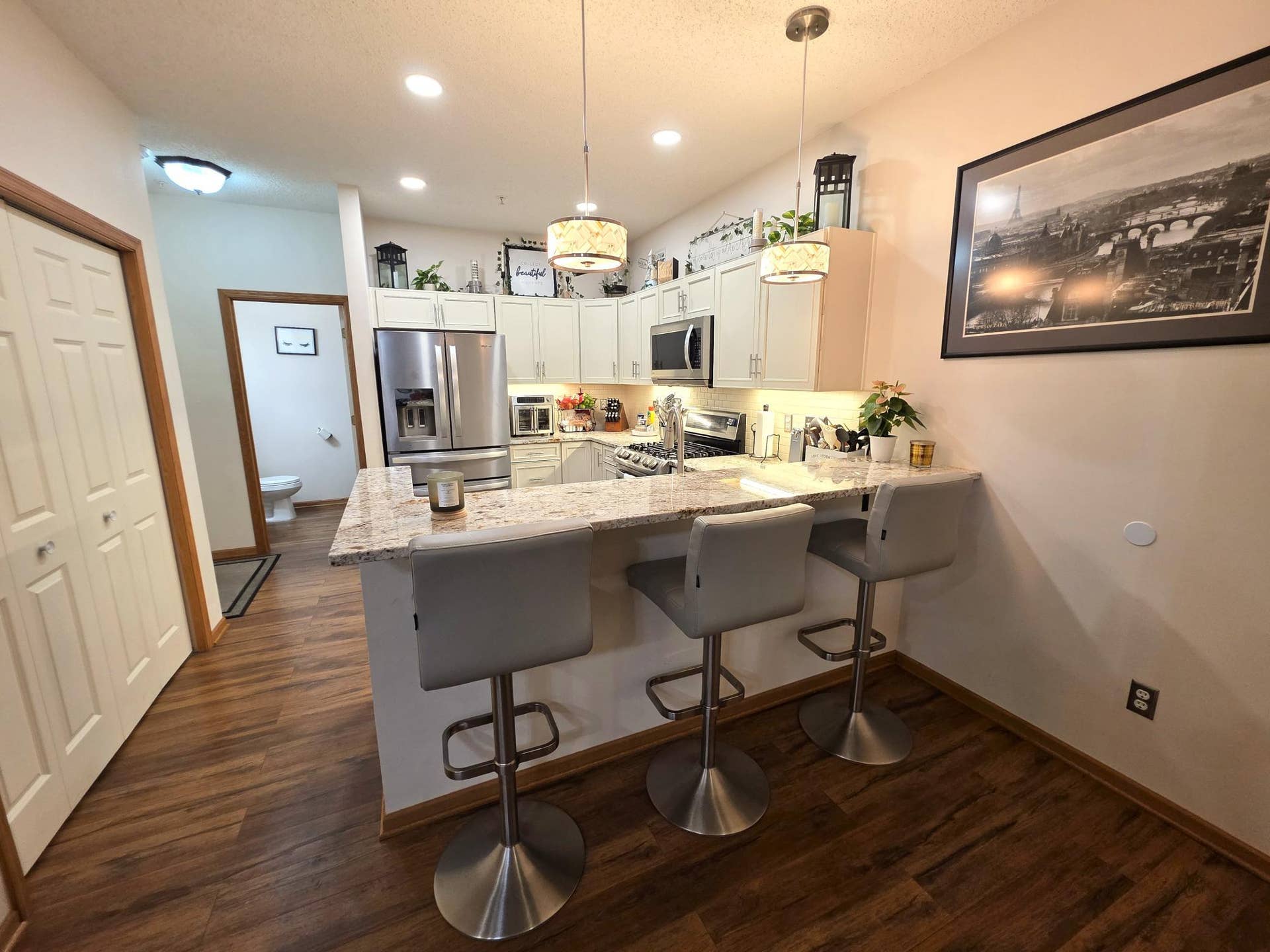 1611 Woodlynn Avenue, #3, Maplewood, MN 55109 The modern kitchen features granite countertops, stainless steel appliances, and breakfast bar seating. Its perfect for quick meals and gatherings.