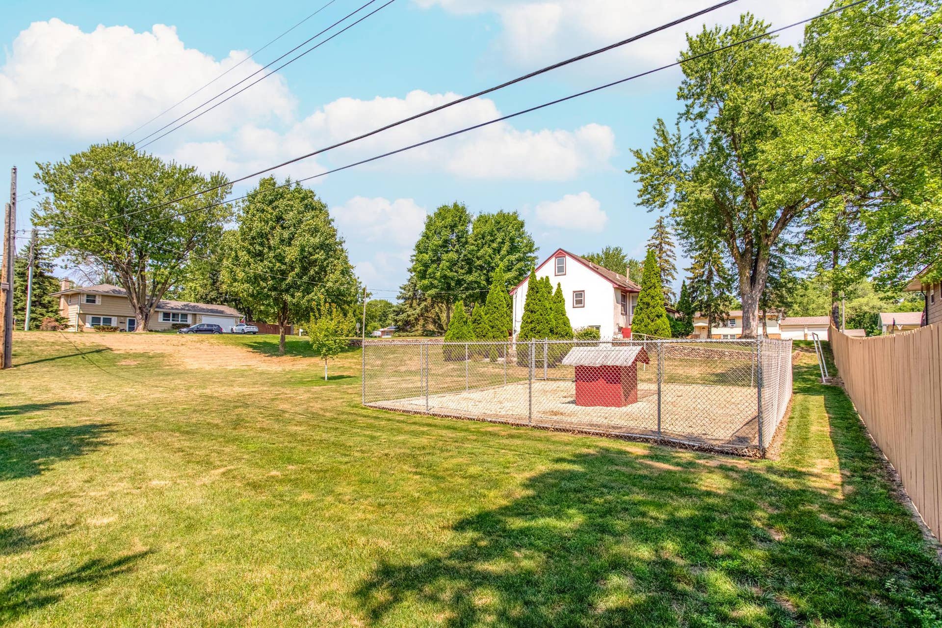 Expansive yard space showcases the park-like setting, with mature trees and plenty of open lawn to enjoy.