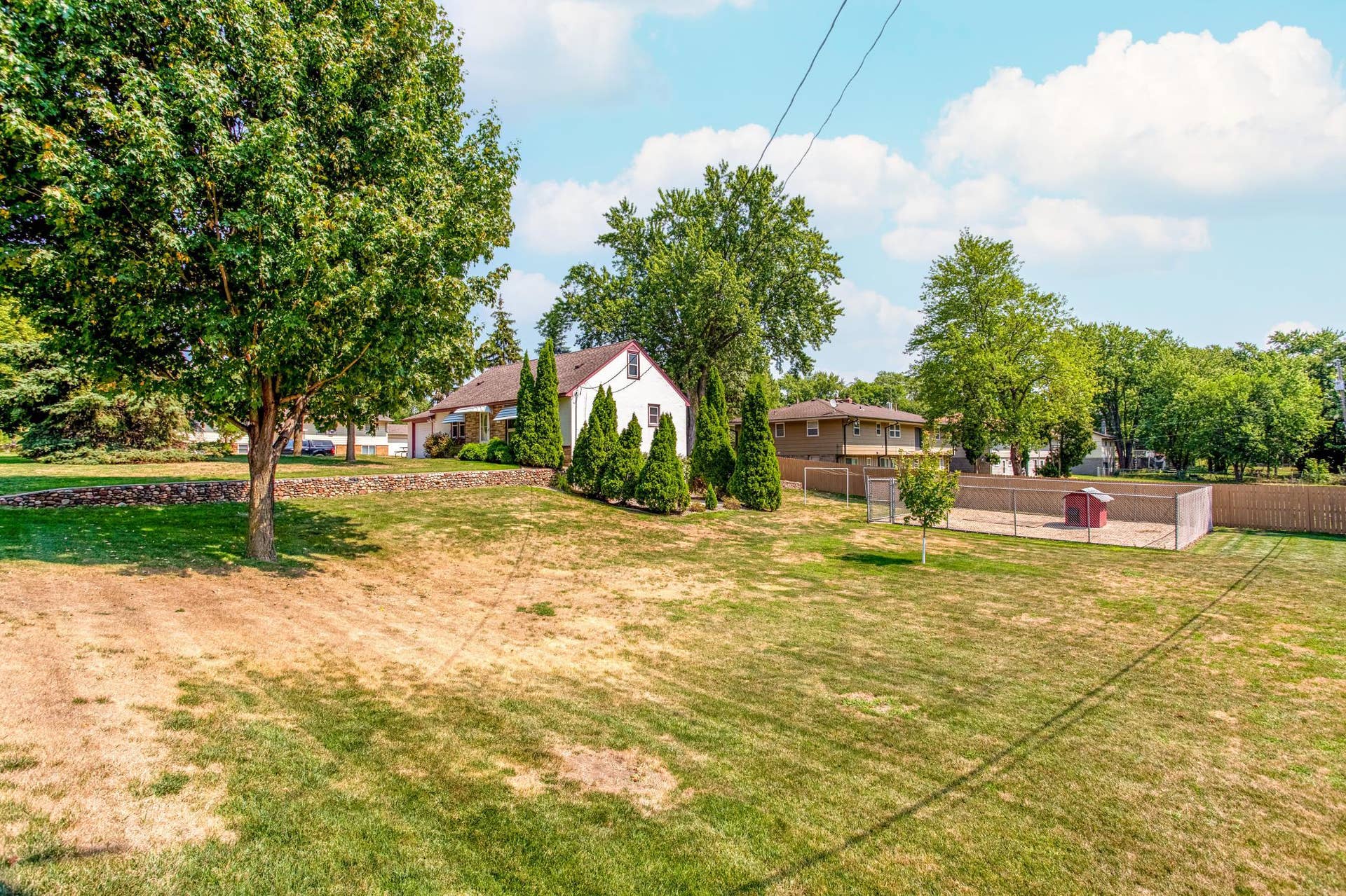 Wide backyard view captures the impressive scale of the double lot, offering abundant space for outdoor recreation, gardening, entertaining, and more.