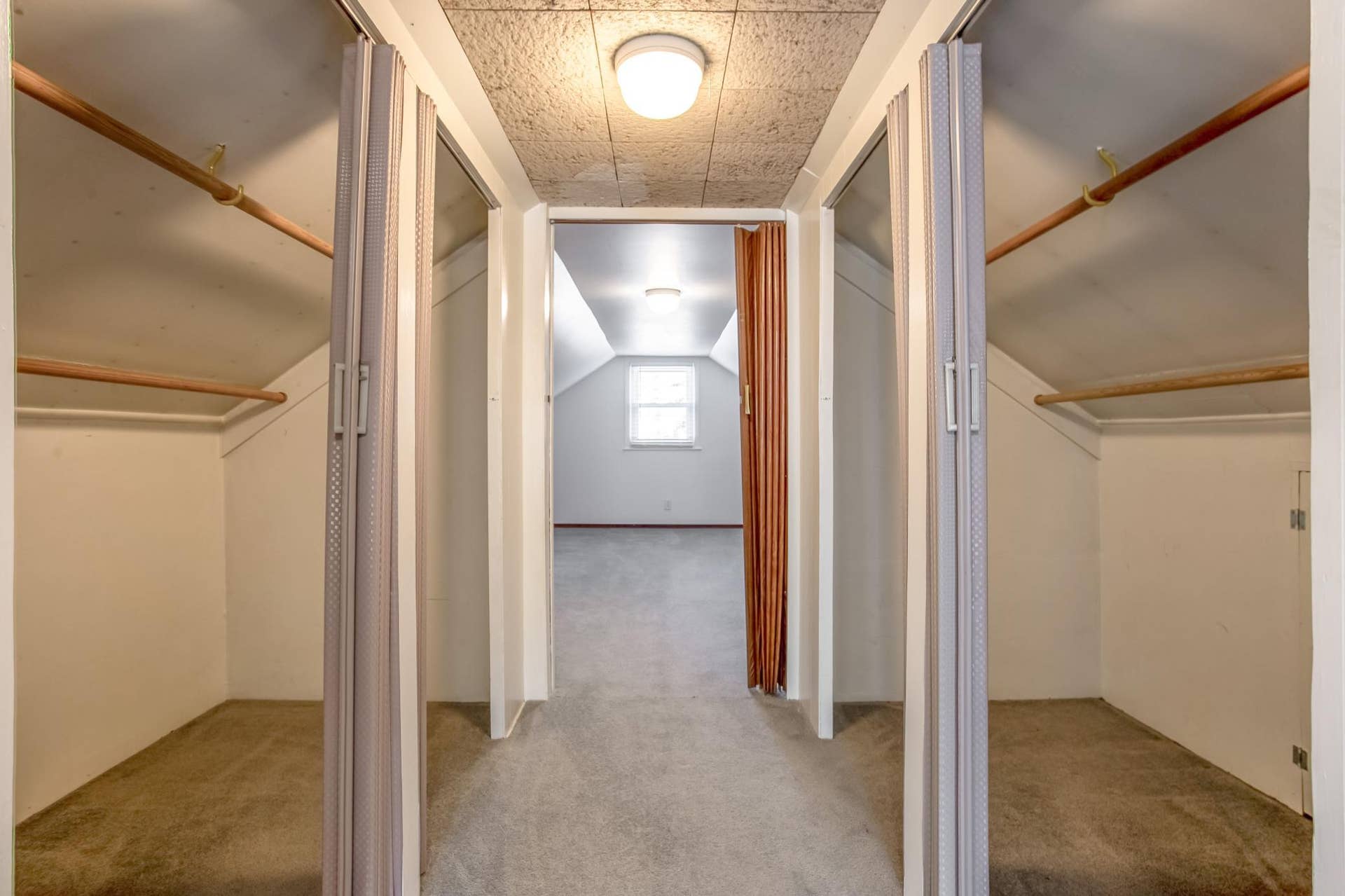 Upper-level hallway provides access to substantial closet and storage areas, maximizing the home's usable space.
