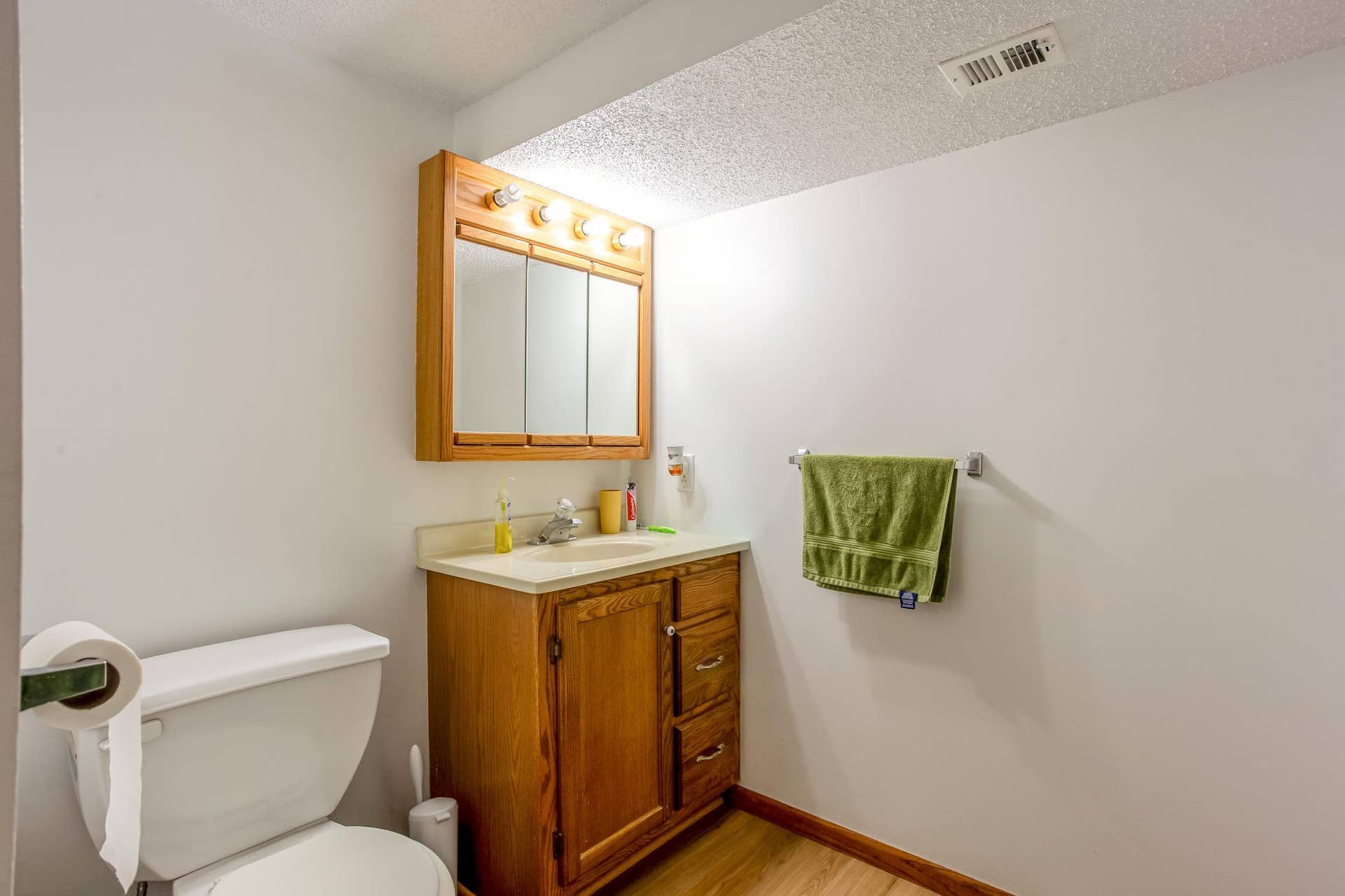 Lower-level bathroom features a separate shower and a practical layout for added household convenience.