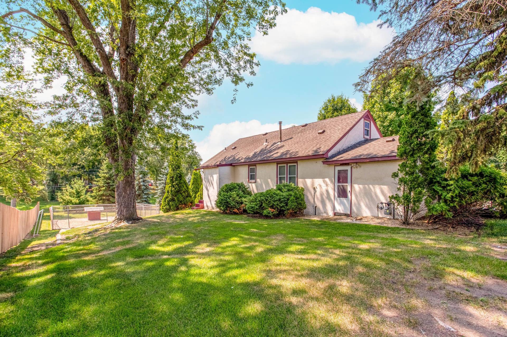 Mature shade trees and established landscaping create a peaceful backyard setting with plenty of room to relax and enjoy the outdoors.
