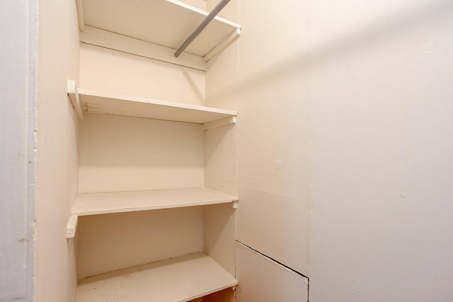 Convenient built-in storage provides multiple shelves and hanging space for organized everyday essentials near the stairs leading to the upper-level.
