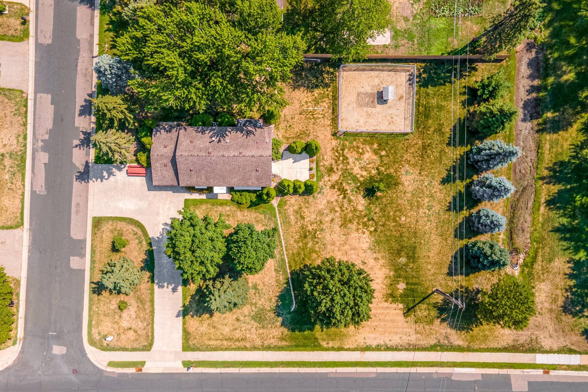 The expansive double lot provides plenty of room to enjoy the outdoors, with a pull-through driveway and mature trees adding beauty and character throughout the property.