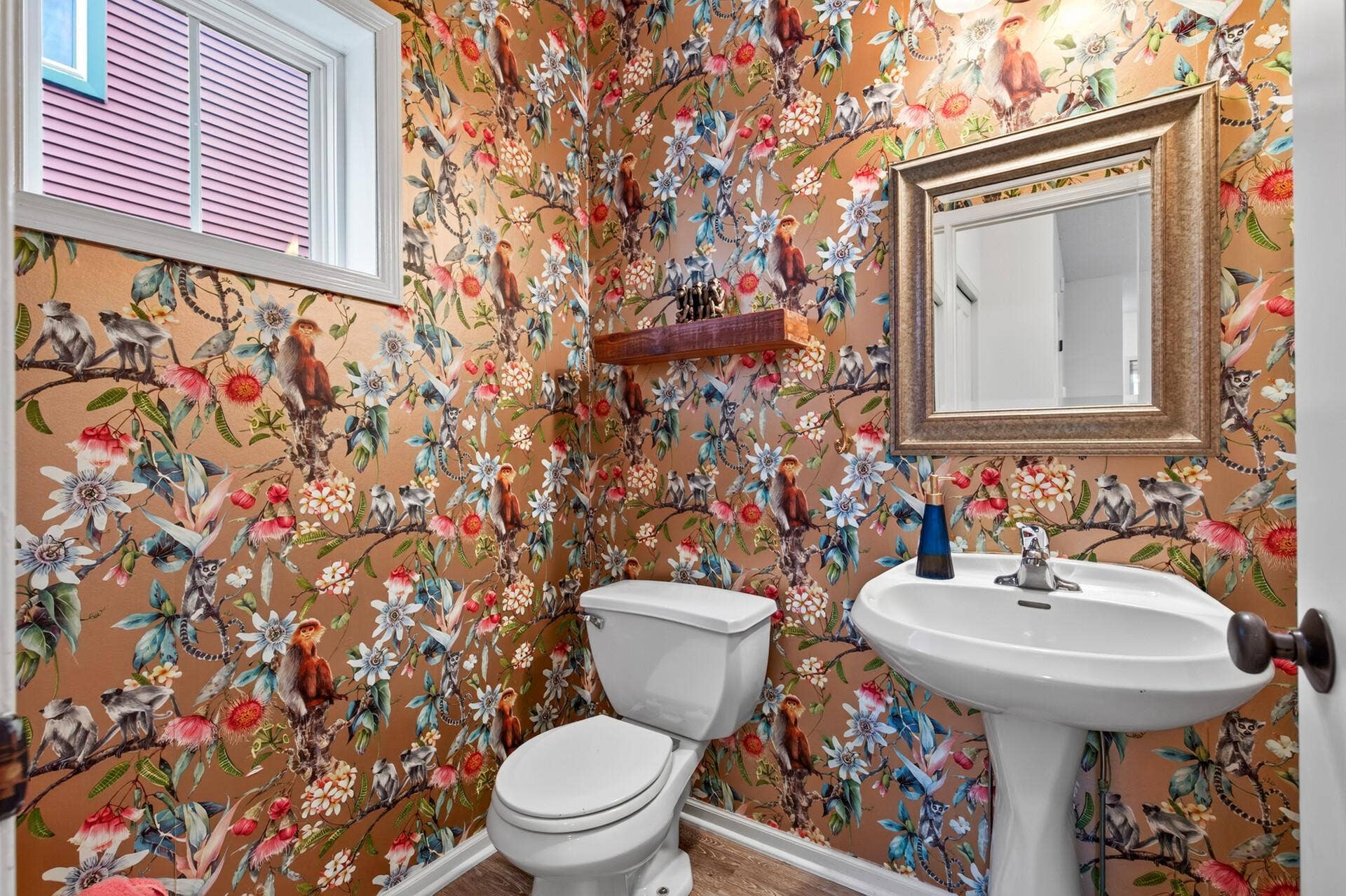 First floor half bath with floral wallpaper