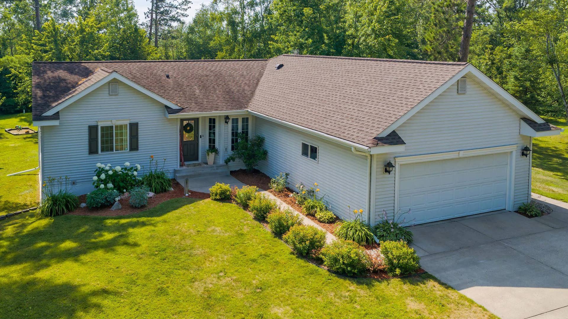 501 Whisperwood Court SW, Bemidji, MN 56601 FRONT OF HOME LANDSCAPE.jpeg