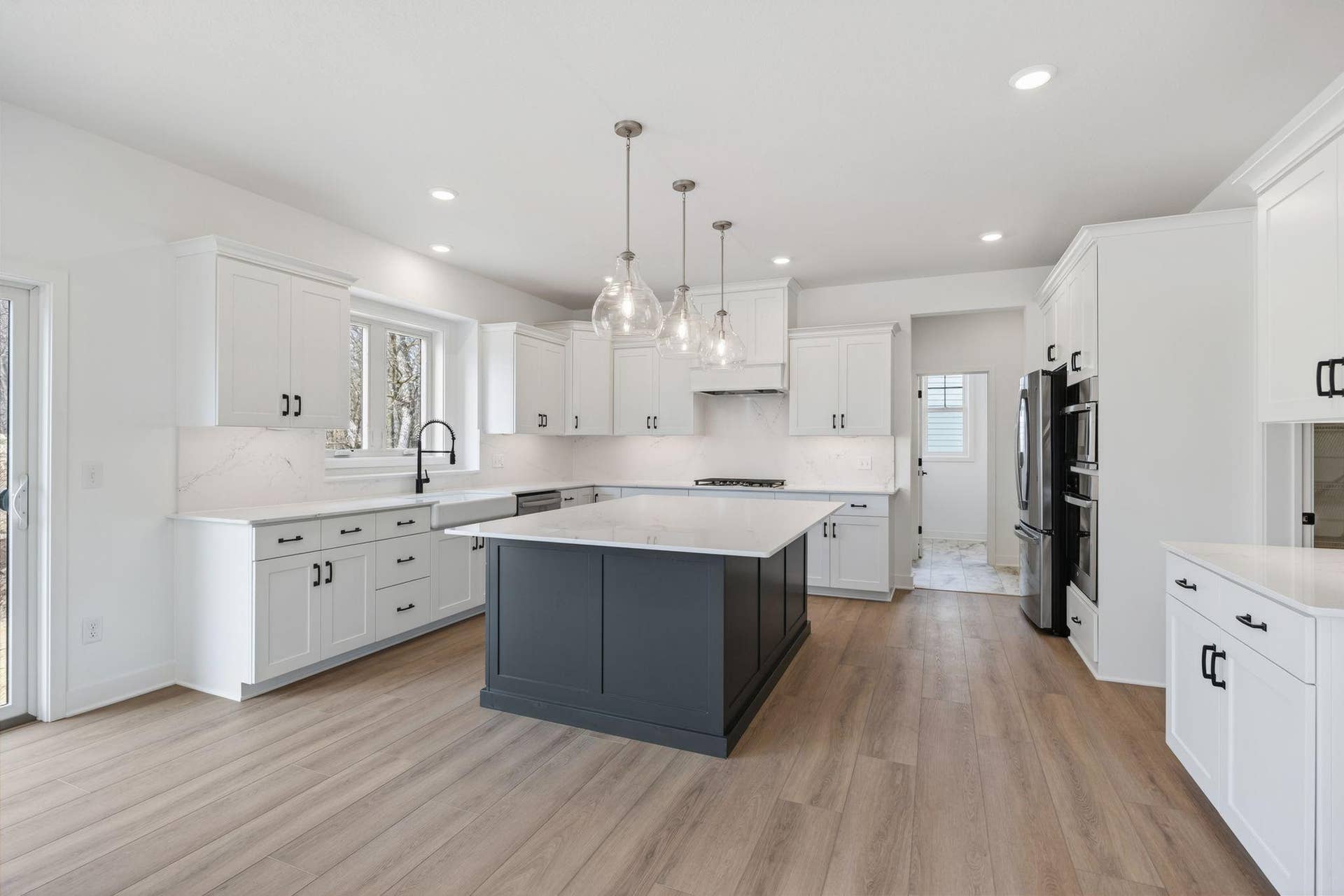 11180 Masters Street N, Lake Elmo, MN 55042 (Photo of a similar home, actual finishes may vary) Melding seamlessly with a breakfast room for casual meals, the sunlit kitchen comes equipped with popular features and a spacious pantry that makes it equal parts functional and stylish.