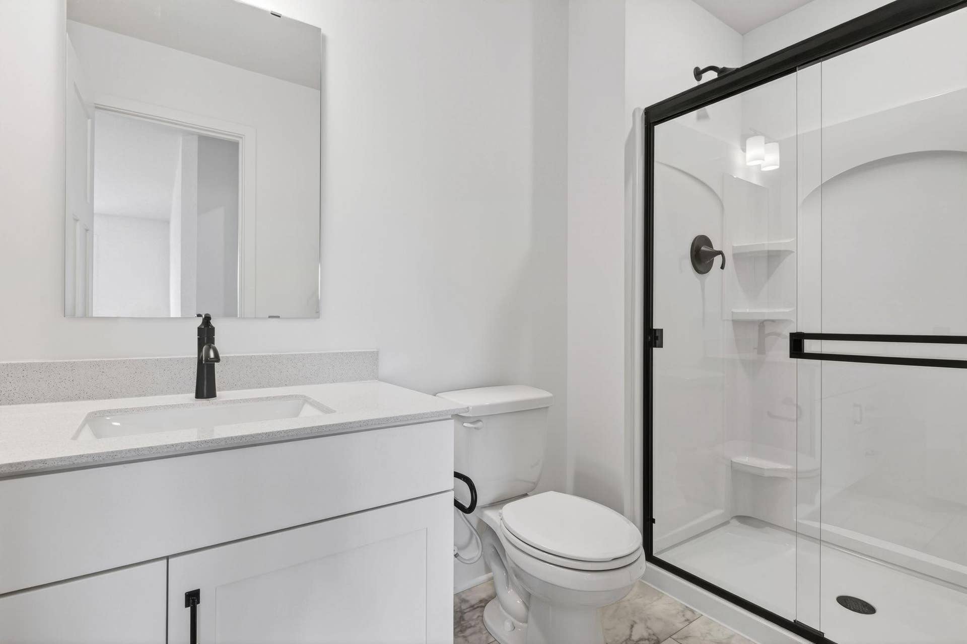 11180 Masters Street N, Lake Elmo, MN 55042 (Photo of a similar home, actual finishes may vary) A private bathroom offers a shower with built-in shelves and a quartz-topped vanity with a Moen chrome-finish faucet