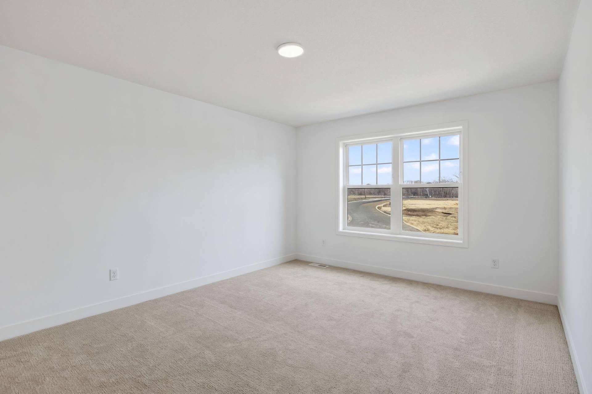 11180 Masters Street N, Lake Elmo, MN 55042 (Photo of a similar home, actual finishes may vary) Situated on the second floor, this secondary bedroom features a walk-in closet offering ample space for wardrobe storage.
