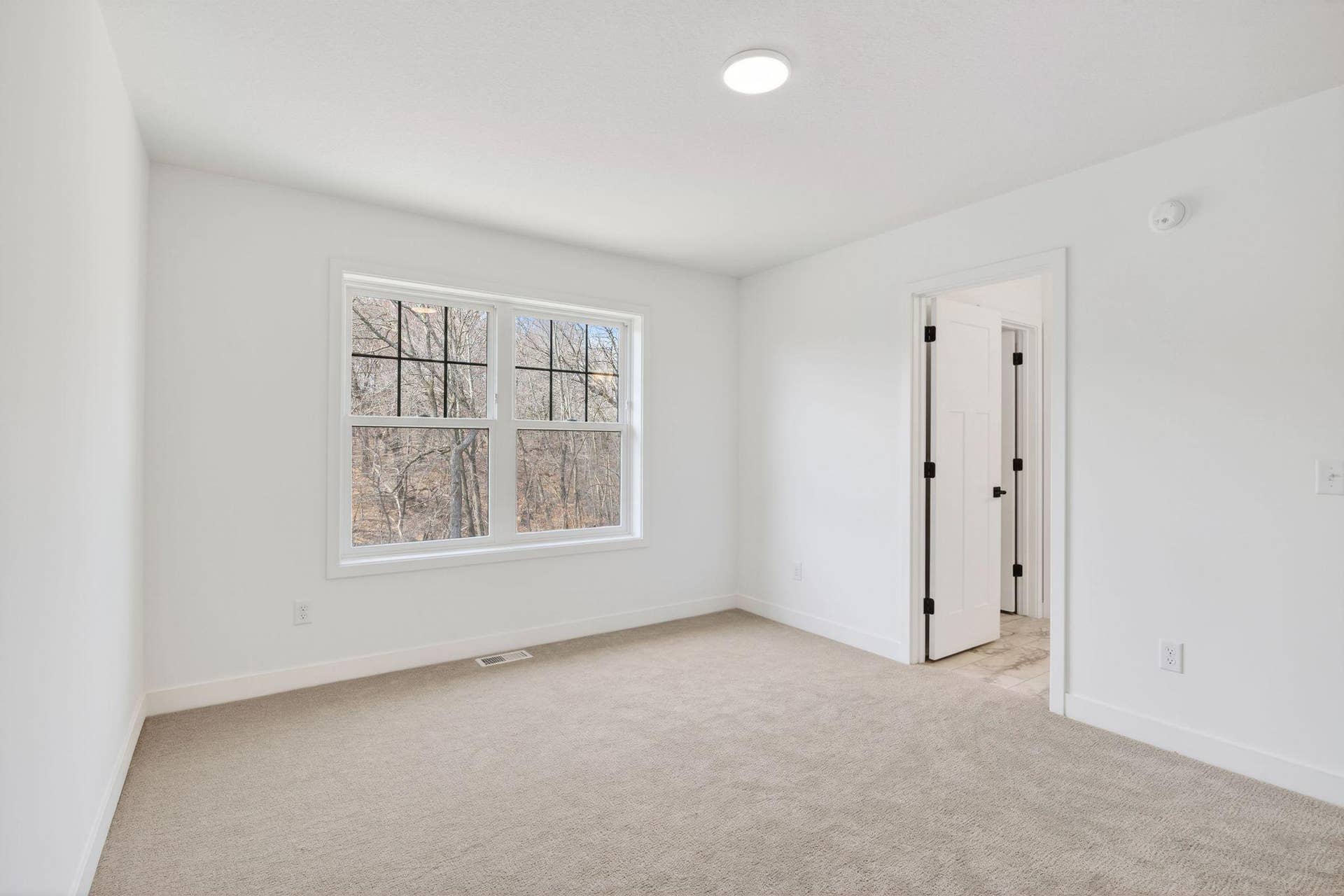 11180 Masters Street N, Lake Elmo, MN 55042 (Photo of a similar home, actual finishes may vary) This bedroom located on the second floor features an en-suite bathroom and a walk-in closet.