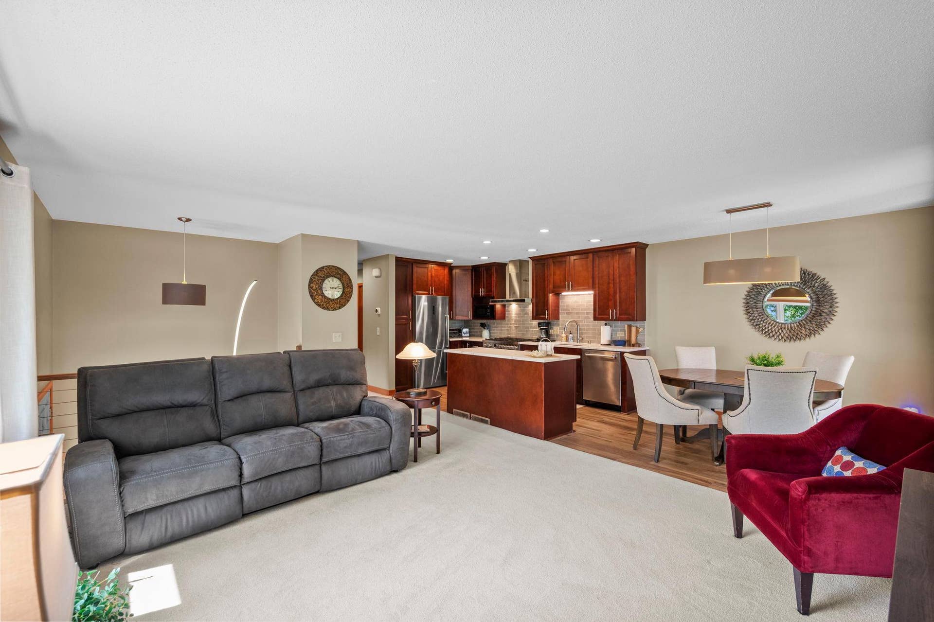 14333 91st Place N, Maple Grove, MN 55369 Open living area includes a high-end kitchen with island and stainless steel appliances.