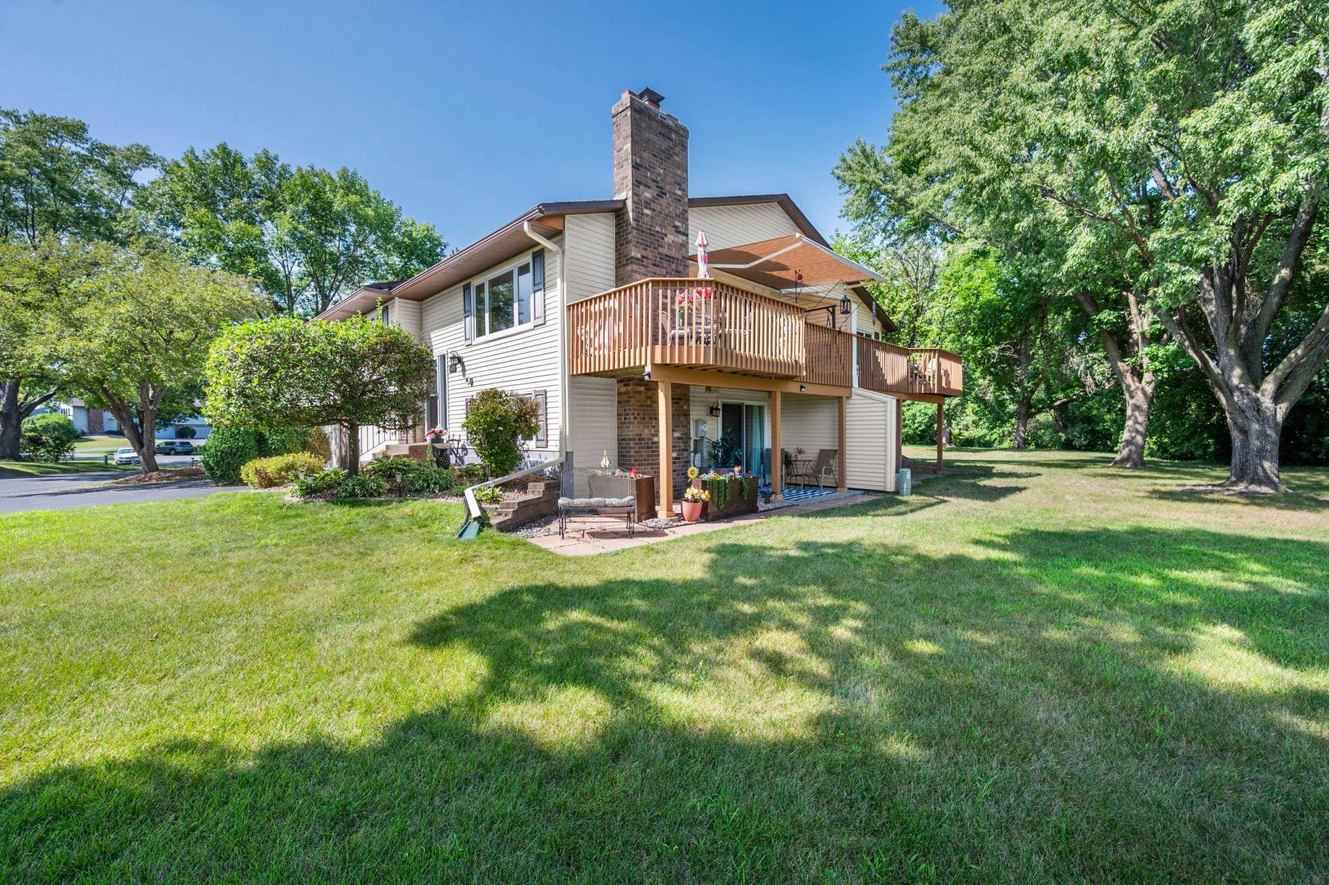 14333 91st Place N, Maple Grove, MN 55369 Home has a large deck off the dining area and a covered patio off the lower level.