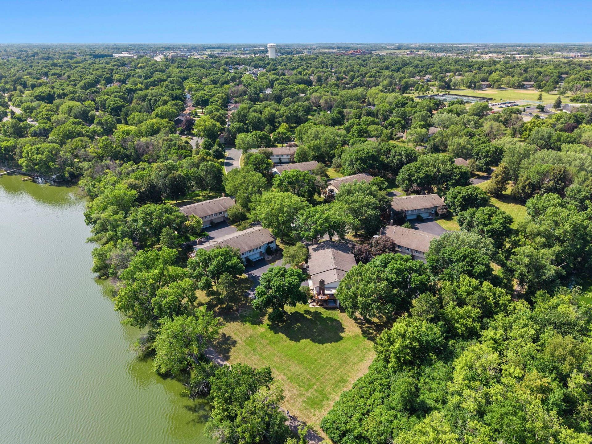 14333 91st Place N, Maple Grove, MN 55369 Drone view of open space (lawn) between the home and the lake