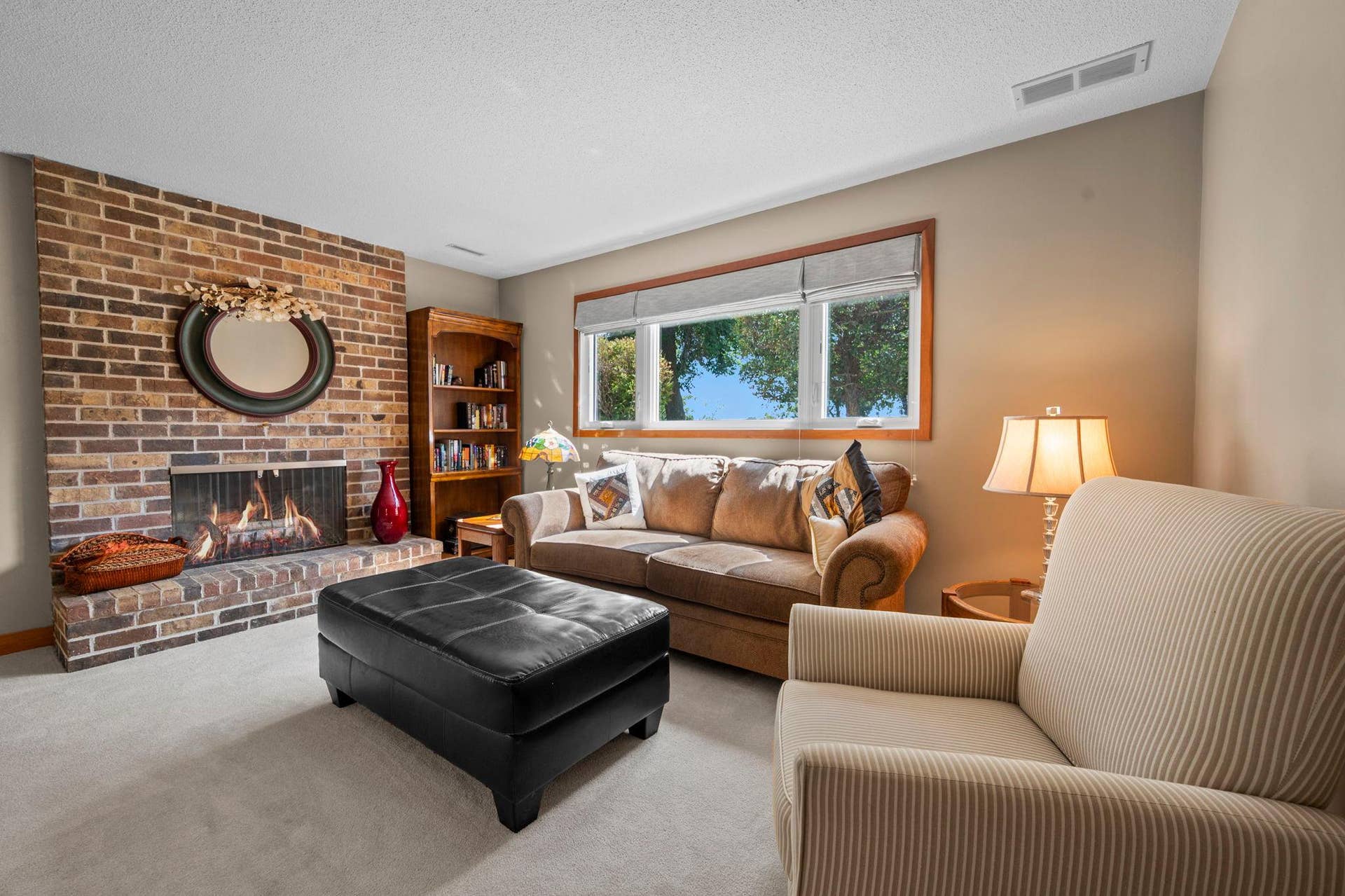 14333 91st Place N, Maple Grove, MN 55369 This beautiful brick fireplace is the focal point of the cozy downstairs family room. Newer windows and neutral carpet.