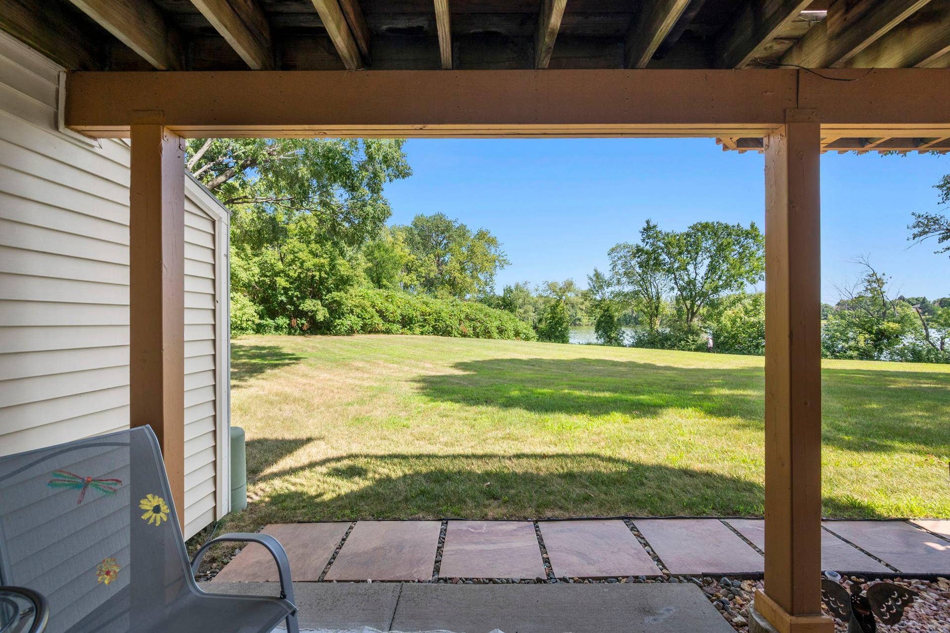 14333 91st Place N, Maple Grove, MN 55369 We are on the covered patio enjoying the beautiful day and gorgeous lake views across the large, shared green space between the house and the lake.