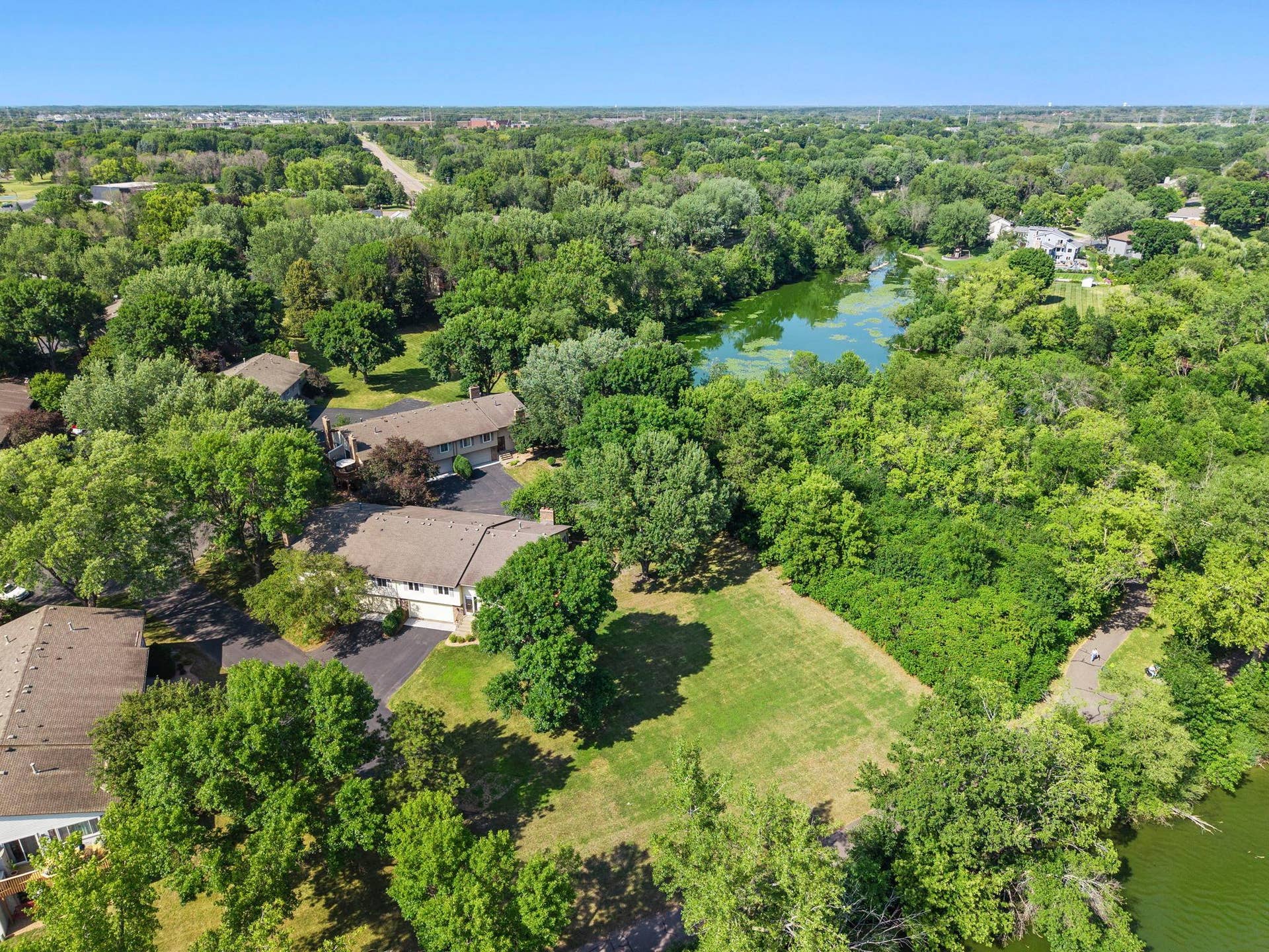 14333 91st Place N, Maple Grove, MN 55369 Drone view open space between lake and home