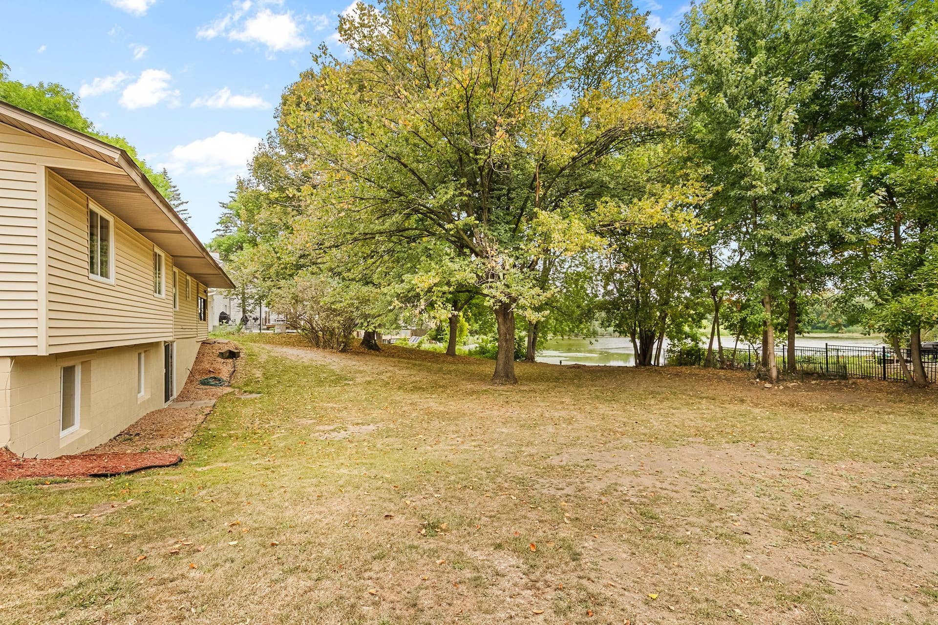 Rare waterfront setting! Enjoy peaceful lake views from the spacious backyard, surrounded by mature treesan incredible setting for relaxing, entertaining and enjoying nature right at home.