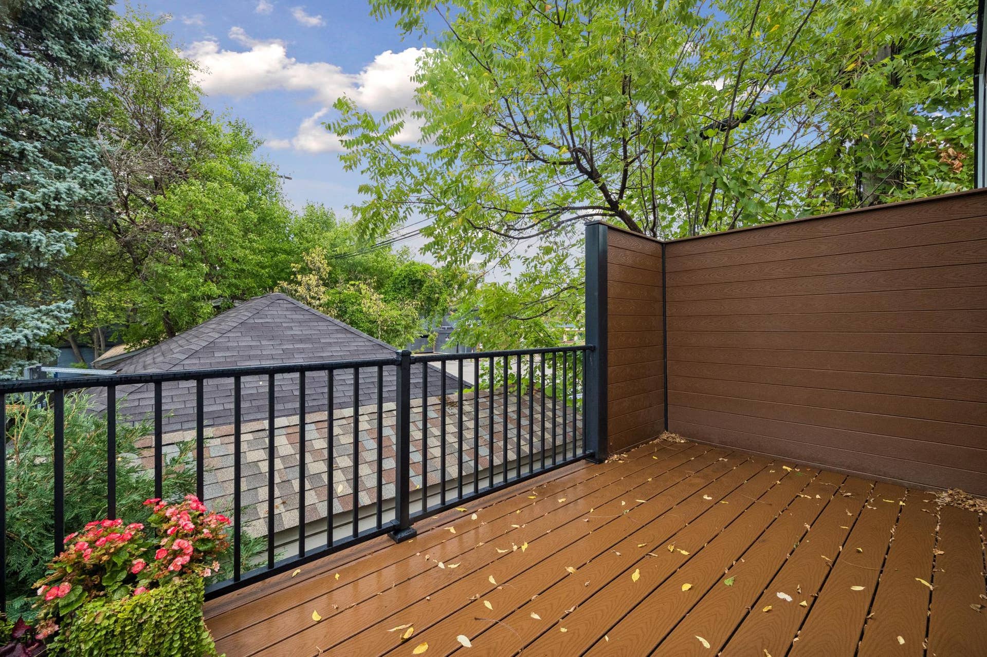2637 1/2 Humboldt Avenue S, 21, Minneapolis, MN 55408 Maintenance-free deck with a privacy wall, offering a comfortable space for outdoor dining and relaxing.