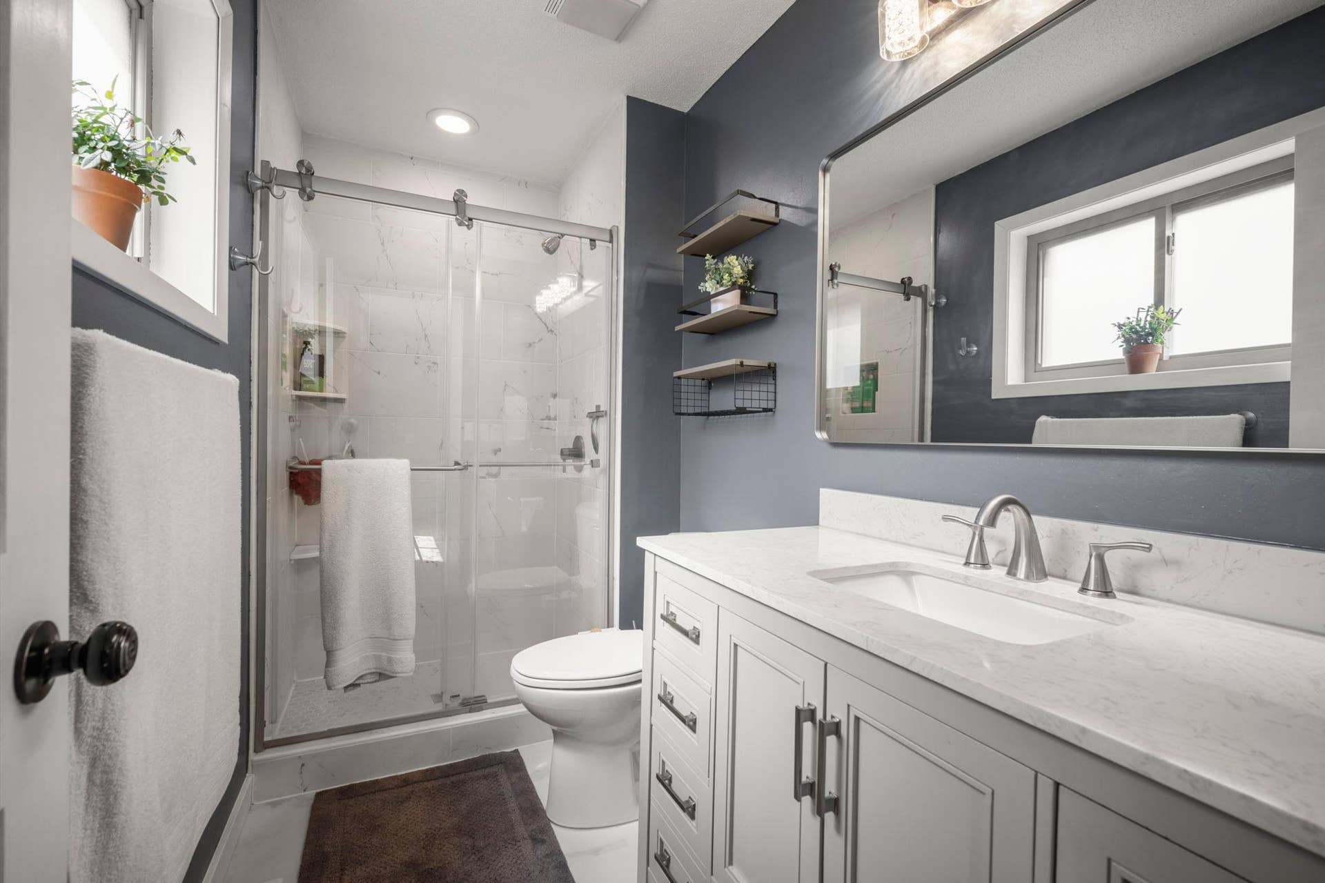 Updated, primary bathroom! Quartz countertops, large vanity and tiled shower and floors.
