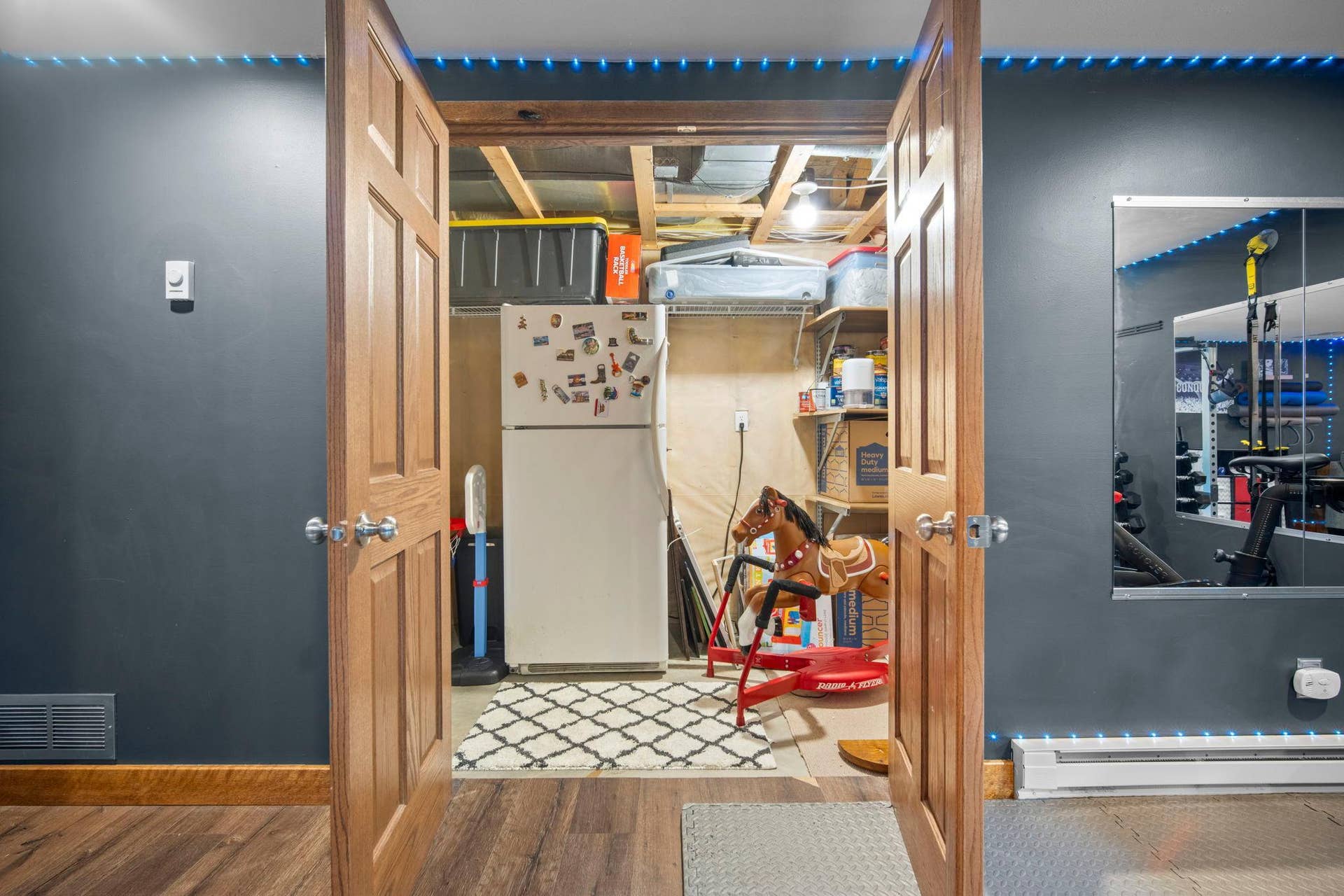 No shortage of storage space with paneled French doors to extra large storage / utility room.