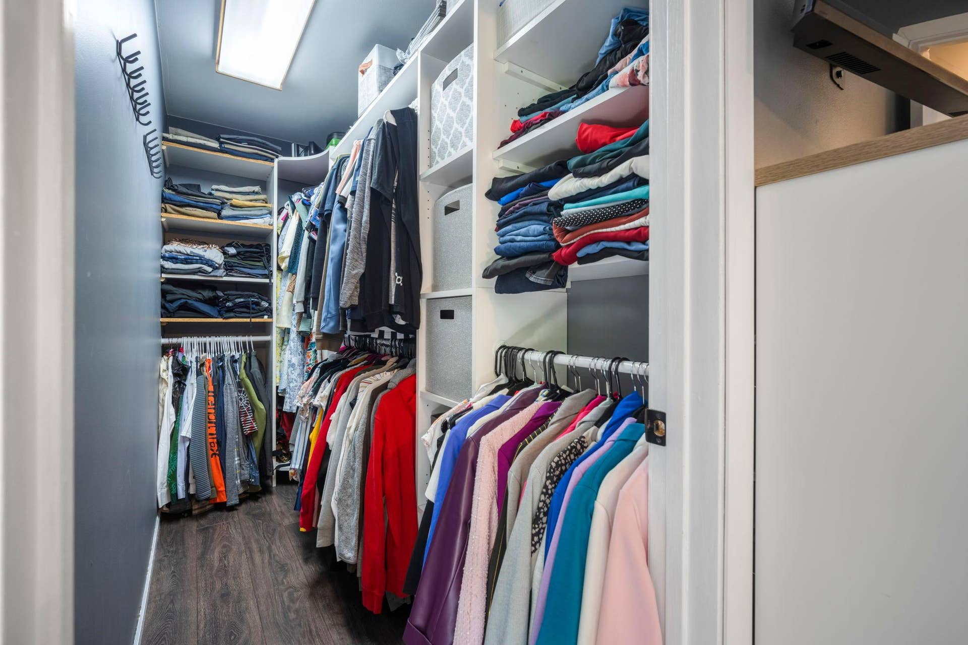 Walk in closet with great organization and shelving!