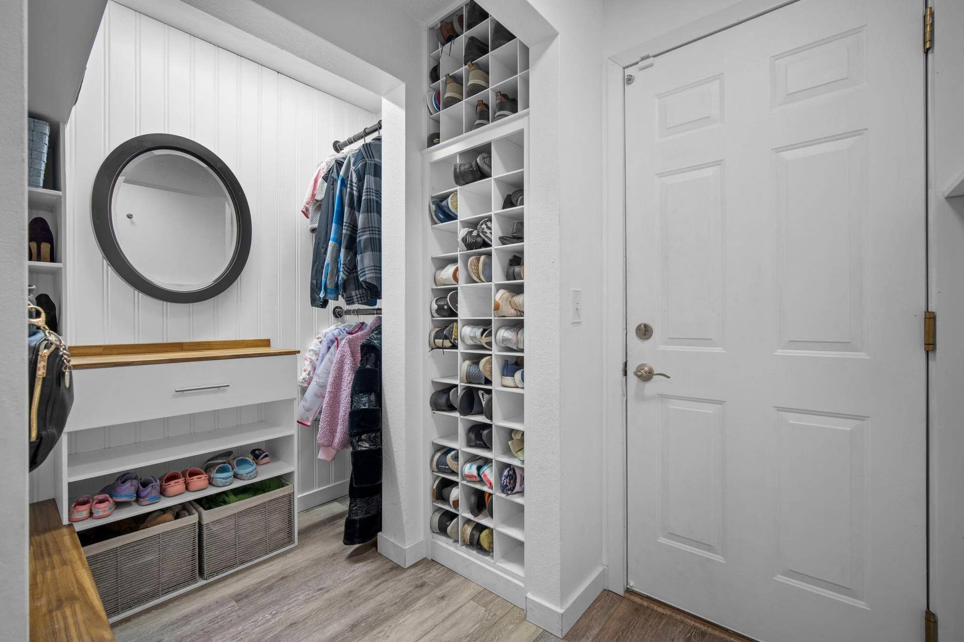 Impressive mudroom with a spacious closet makes staying organized effortless.
