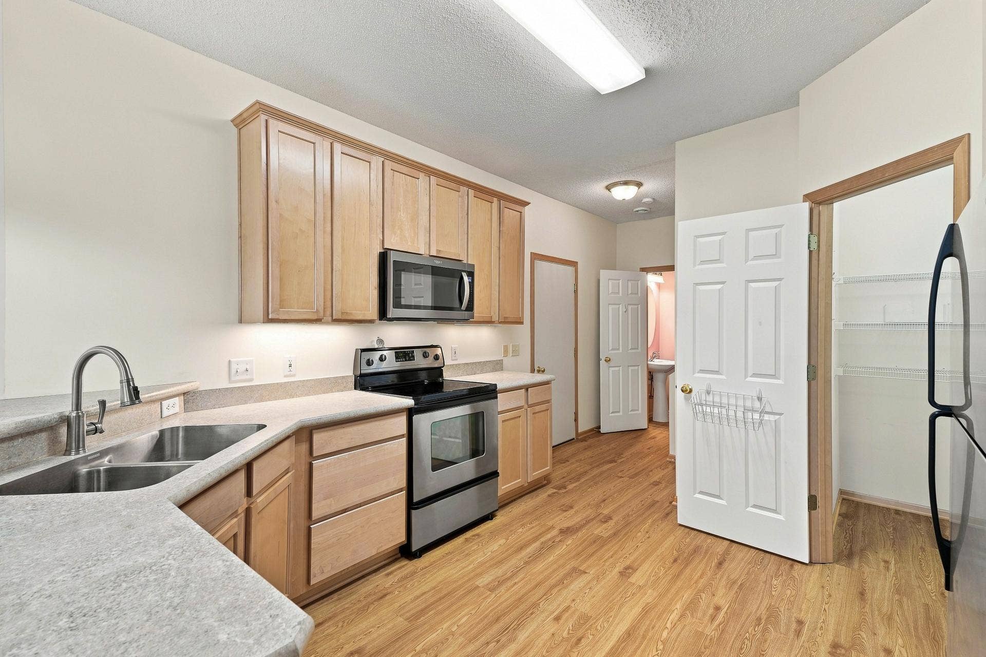 11021 Oak Grove Circle #C, Woodbury, MN 55129 Kitchen with Over the Counter Lighting and Walk-in Pantry