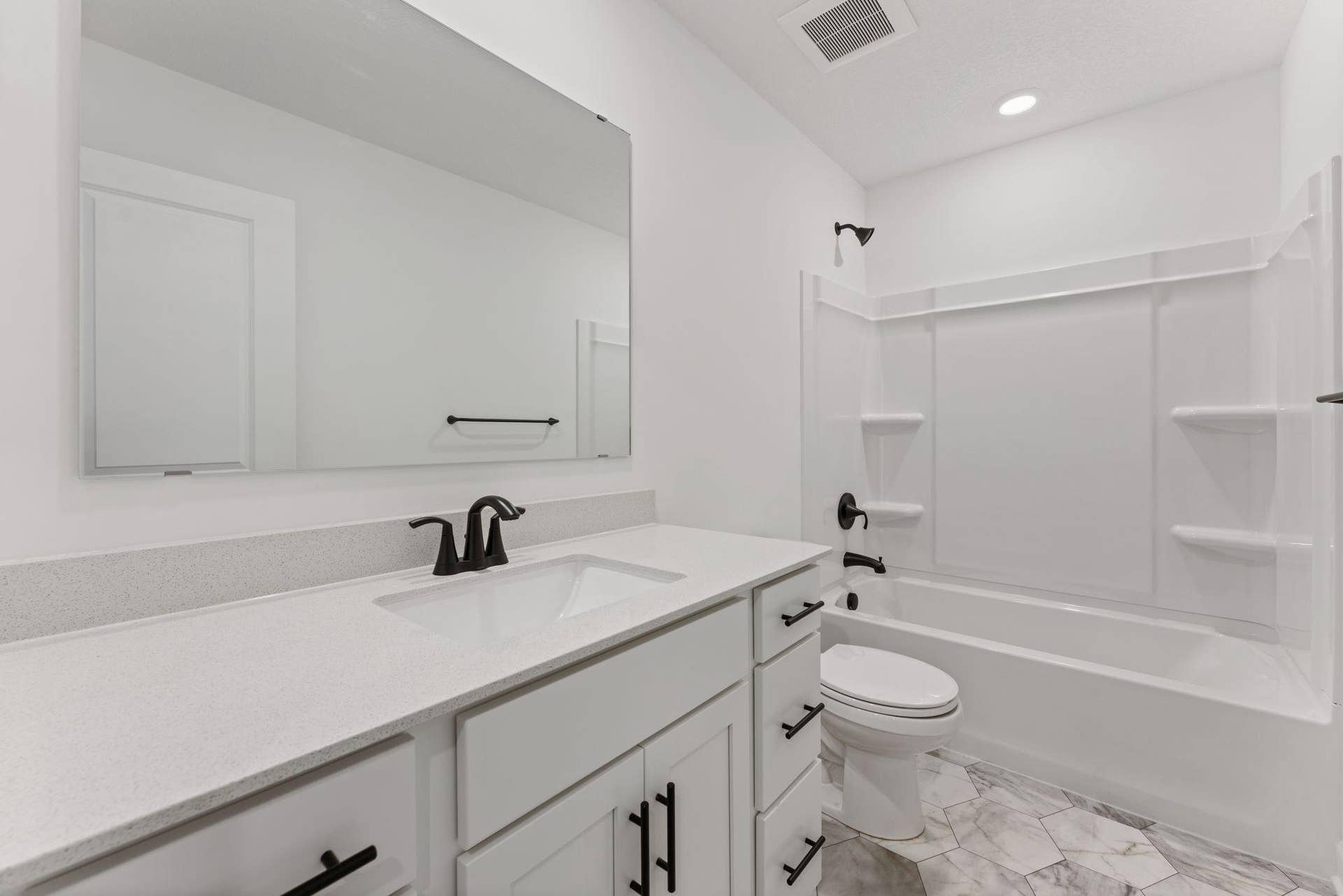 10564 Glacier Lane N, Maple Grove, MN 55369 (Photo of a similar home, actual finishes may vary) Situated near the secondary bedrooms, this full-sized bathroom comes well-equipped with a quartz-topped vanity and a combination shower and tub to maximize the interior space.
