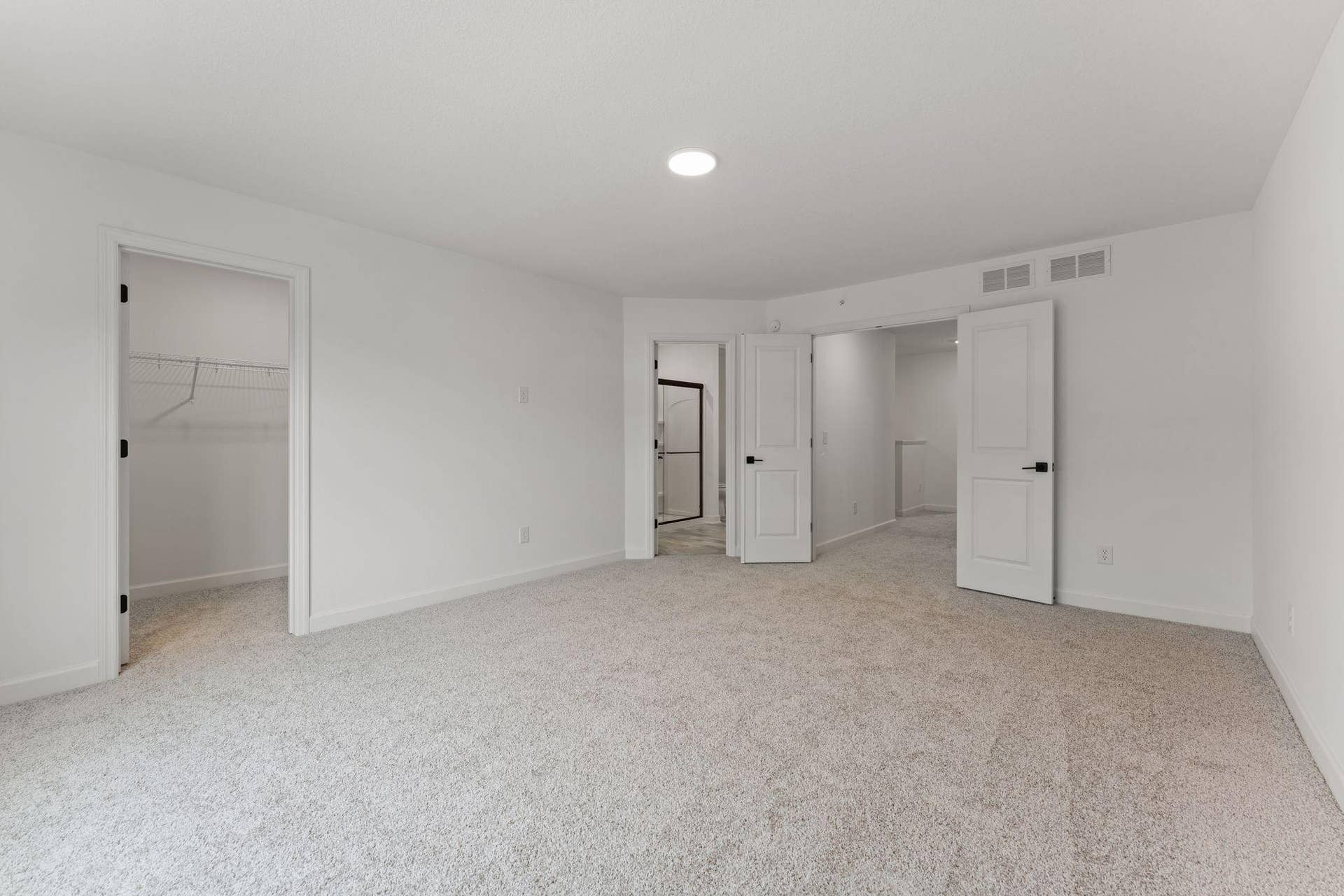 10564 Glacier Lane N, Maple Grove, MN 55369 (Photo of a similar home, actual finishes may vary) The primary bedroom embraces natural light streaming in from the large windows