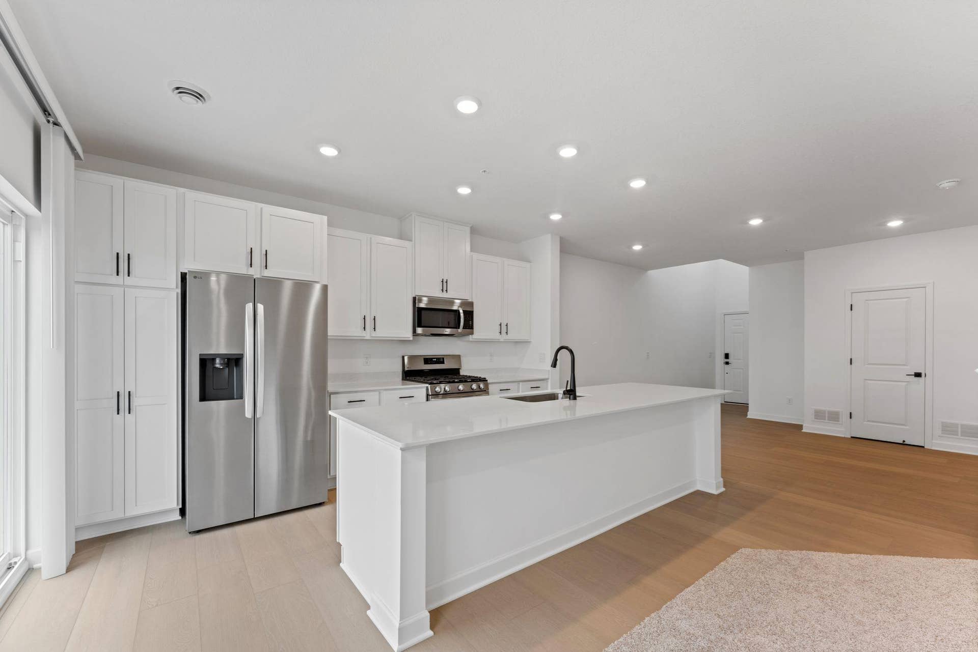 10564 Glacier Lane N, Maple Grove, MN 55369 (Photo of a similar home, actual finishes may vary) At the focal point of this modern kitchen is a quartz-topped center island to add bar-style seating, and all-new stainless steel appliances to craft delicious meals.