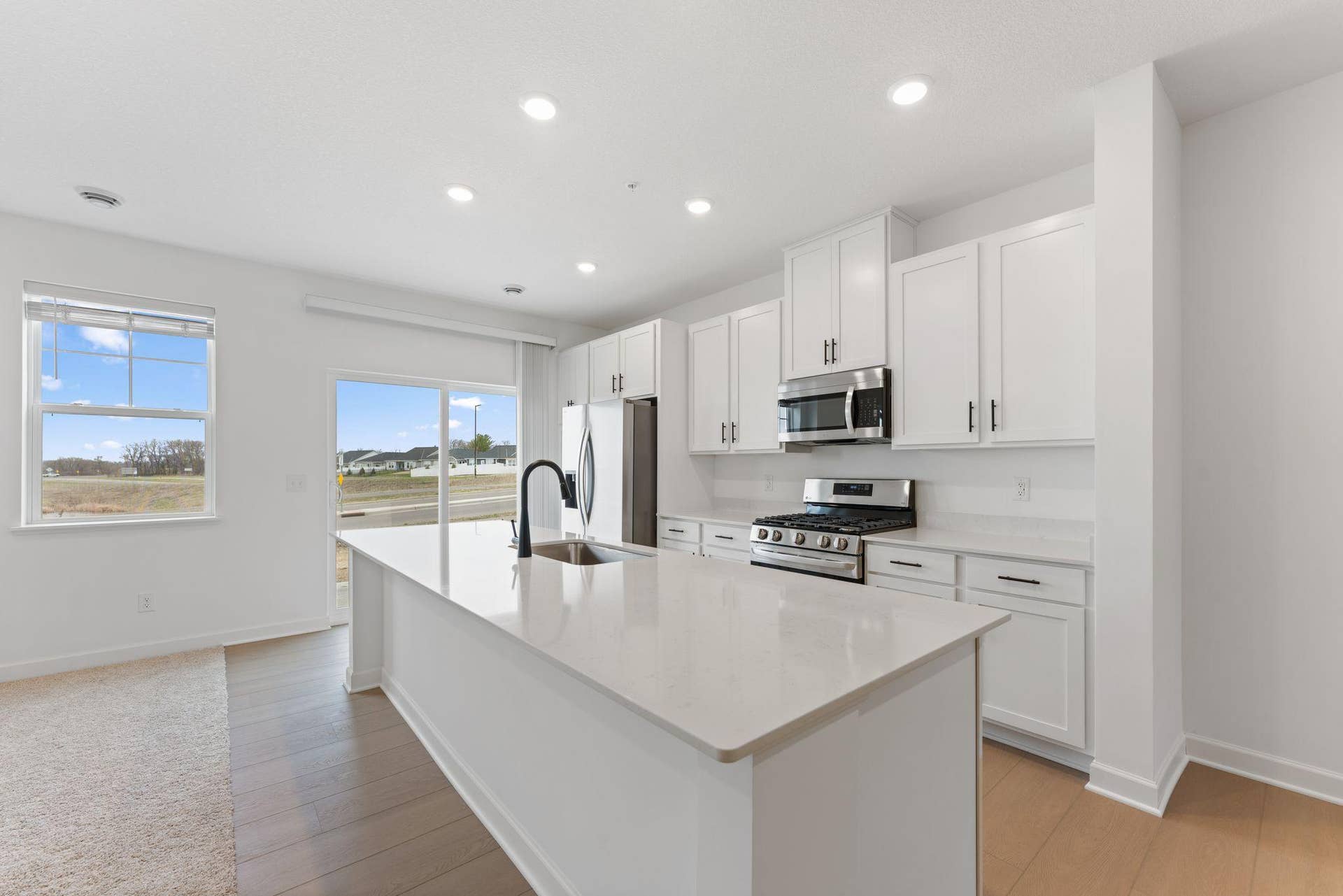 10564 Glacier Lane N, Maple Grove, MN 55369 (Photo of a similar home, actual finishes may vary) Open the sliding glass-doors to welcome a refreshing breeze throughout the interior or venture out to the patio for a breath of fresh air