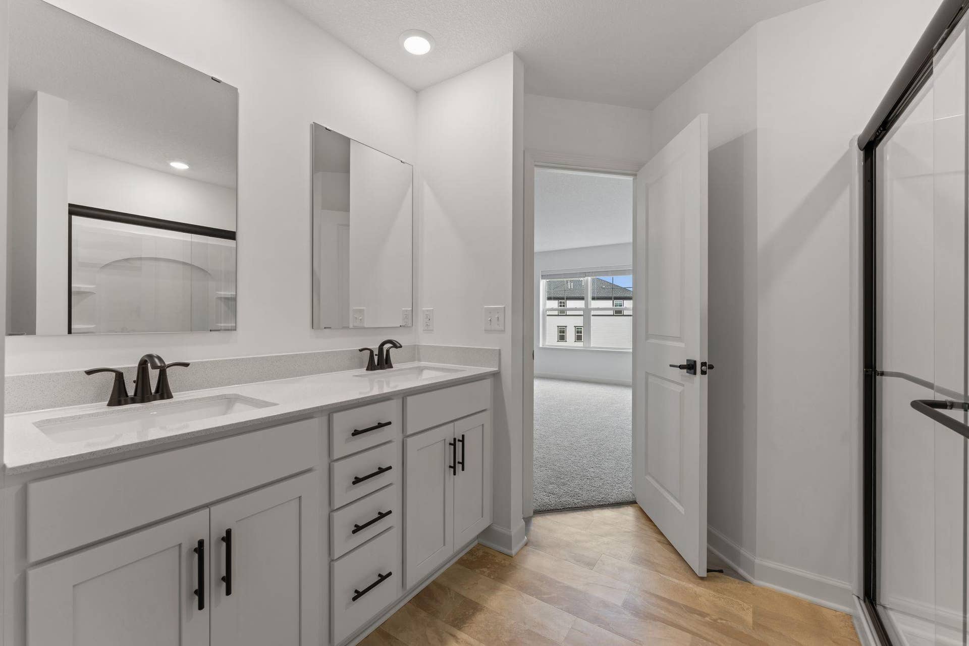 10564 Glacier Lane N, Maple Grove, MN 55369 (Photo of a similar home, actual finishes may vary) Quartz countertops, Moen Glyde faucets and dual sinks come together at this impressive vanity