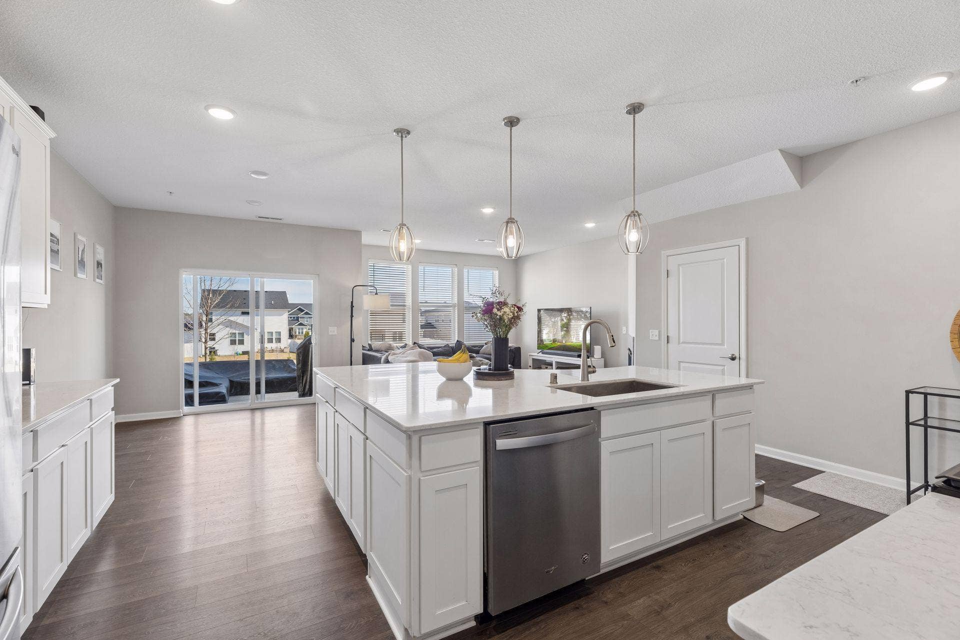 Large kitchen island with built-in dishwasher and sink cutout, ideal for entertaining and daily living.